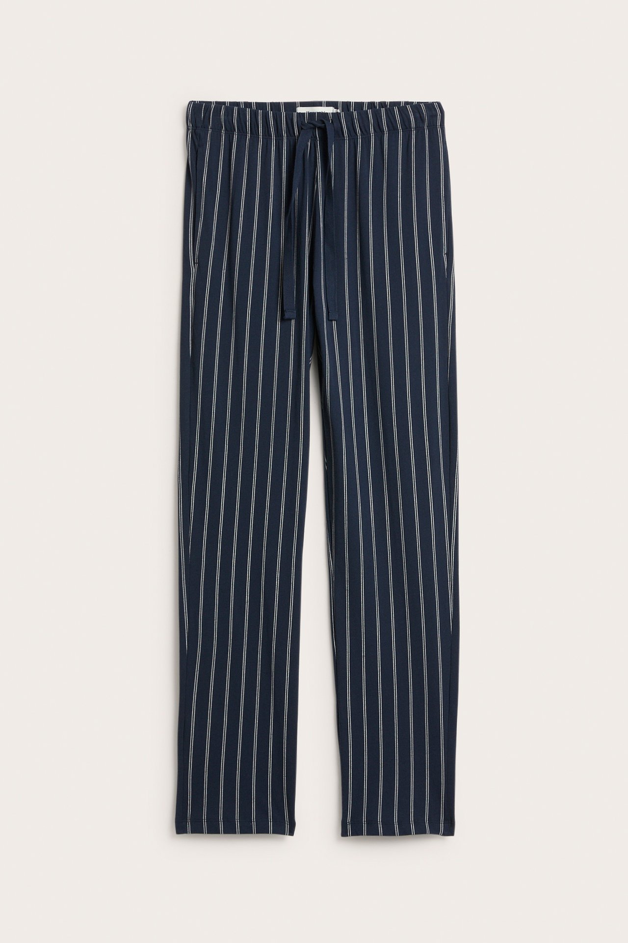 Frontvisning: Mørkeblå pyjamasbukse i bomullsjersey med hvite striper, elastisk midje og snøring.