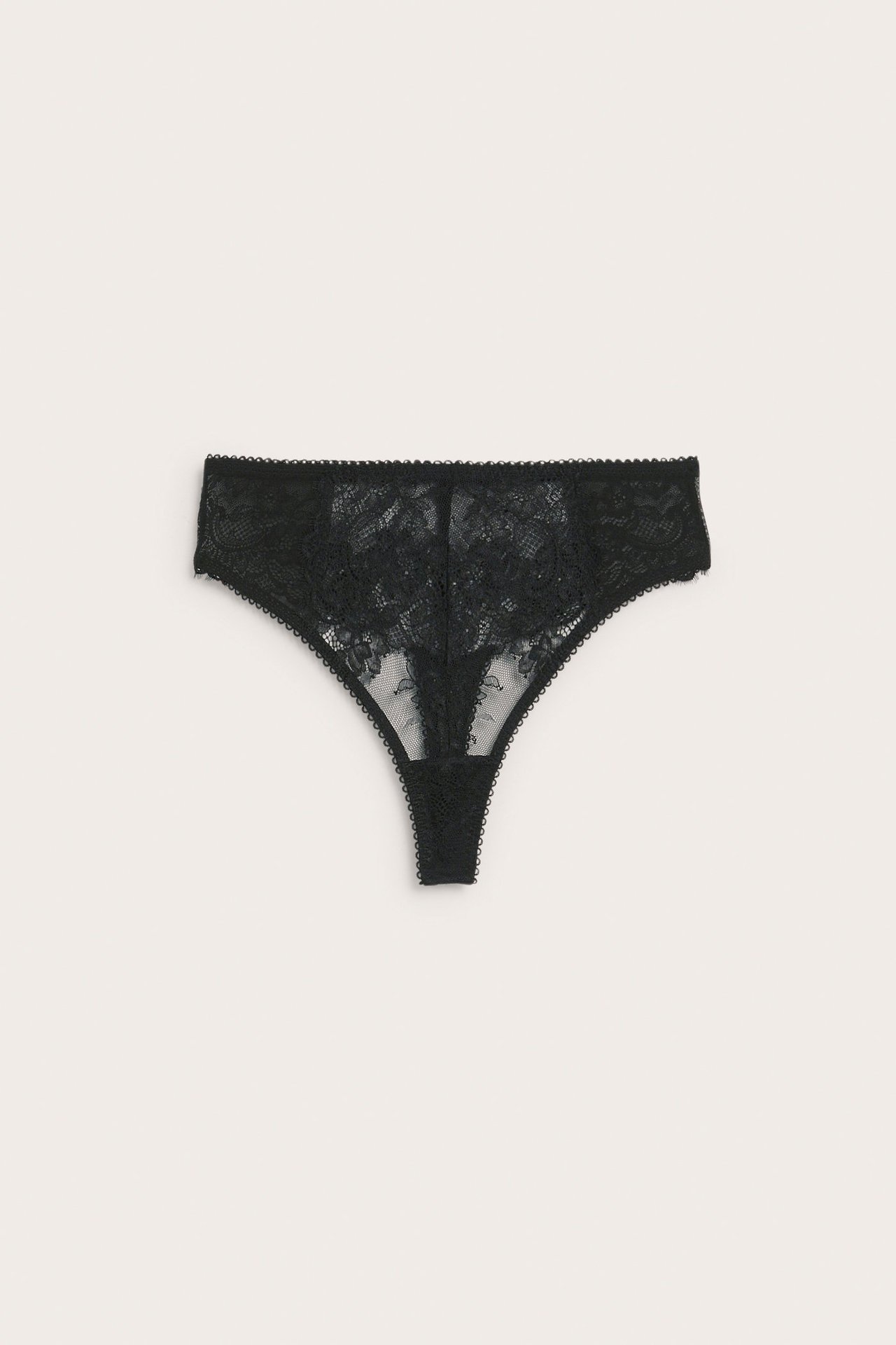 Frontvisning av en svart blondestringtruse med blomstermønster.