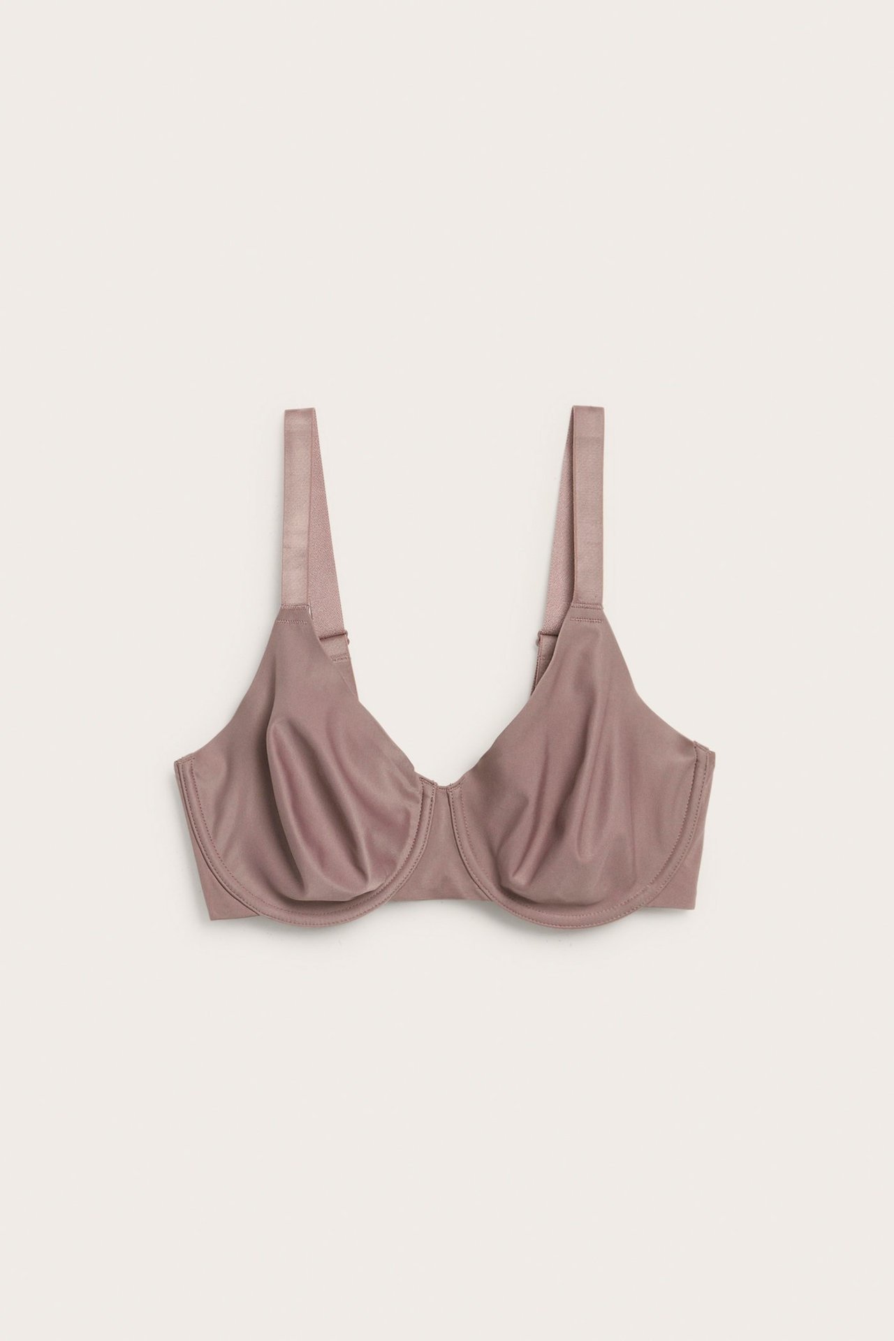Frontbilde av en uforet mørk rosa minimizer-bh med brede justerbare stropper.