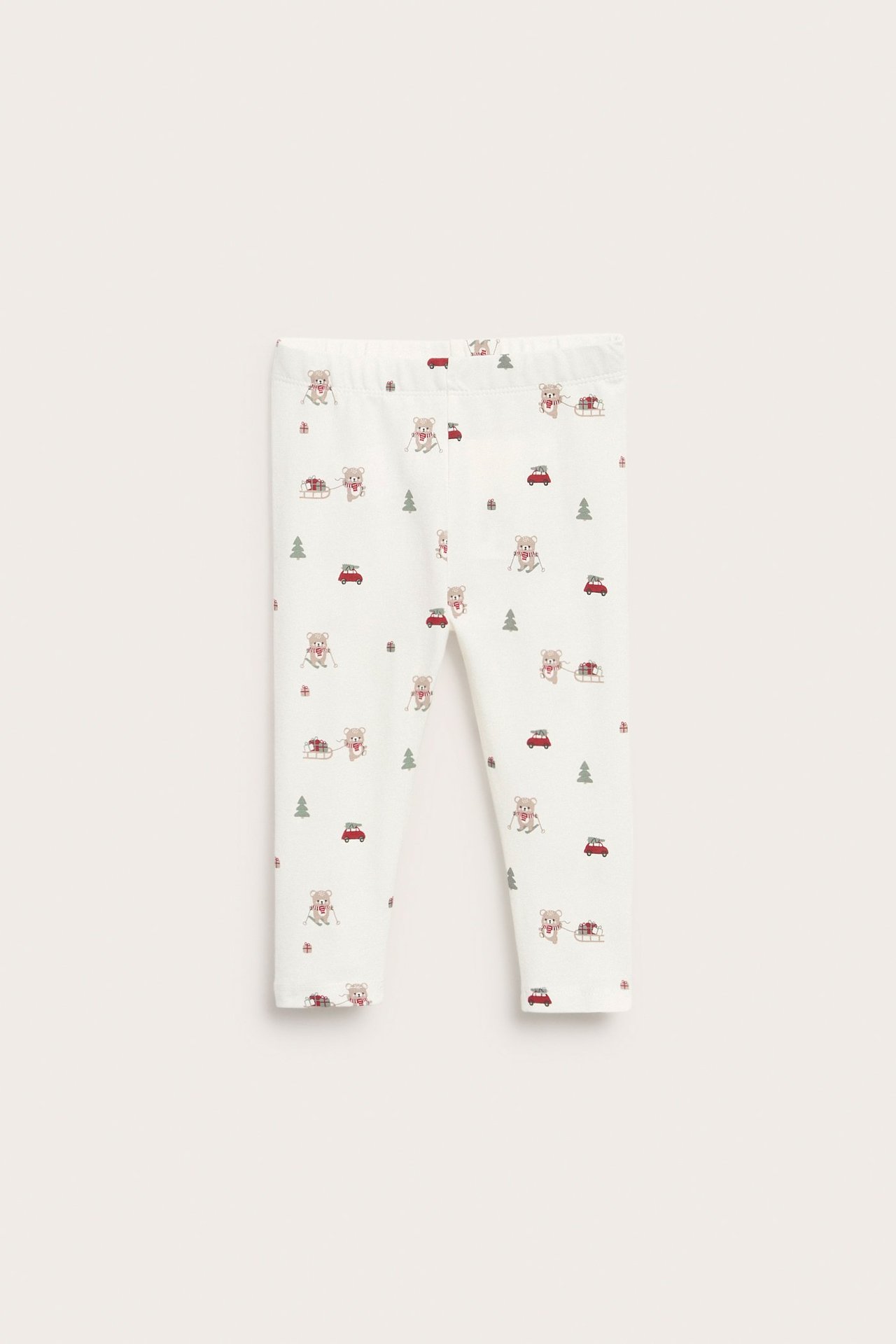 Frontbilde av offwhite baby-leggings i single jersey med julemønster: bamser og røde biler.