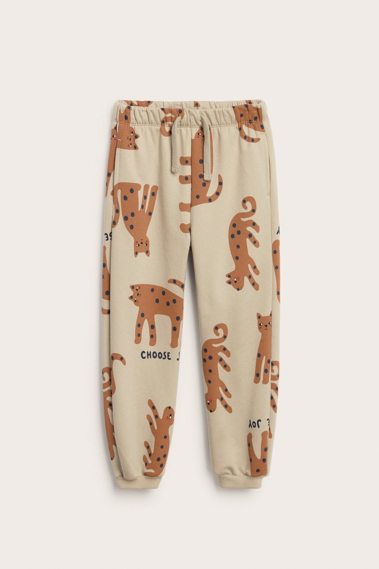 Beige joggebukse med dyremønster, sidelommer, regulerbar midje, ribbekant.