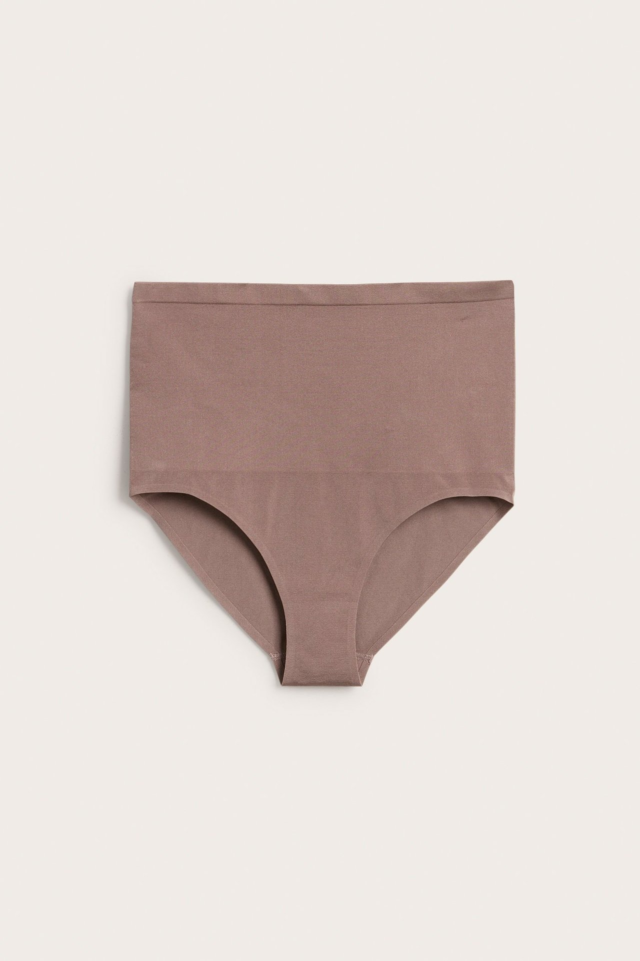 Frontbilde av en mørk rosa sømløs truse med høy midje i elastisk stoff, liggende flatt.