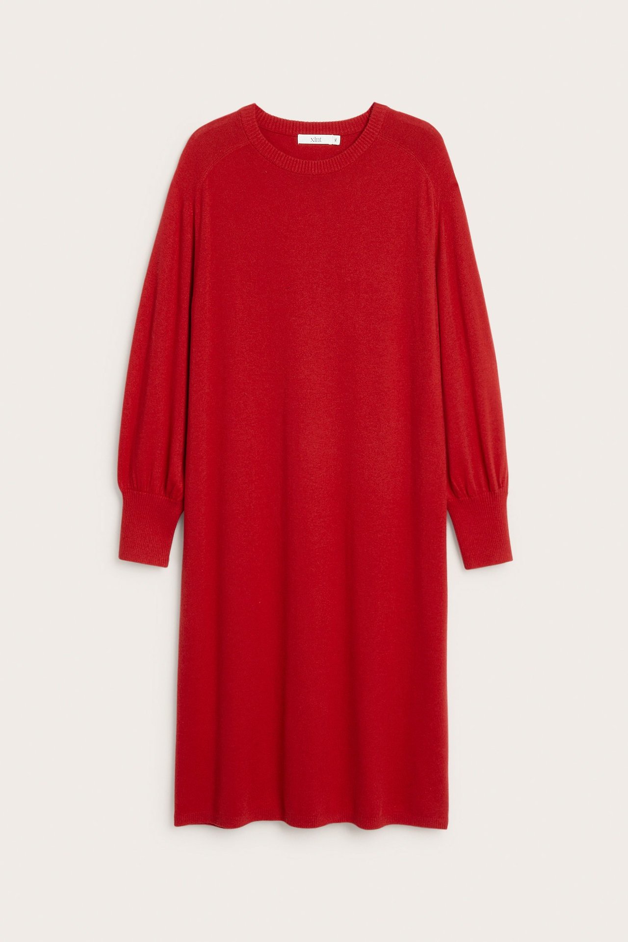 Framifrån, en röd stickad klänning med rund hals, puffärmar och breda ribbade muddar.