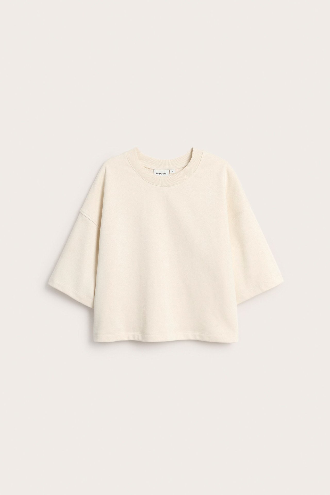 Widok z przodu: kremowa, krótka bluza z krótkim rękawem, luźny krój, z mieszanki bawełny.