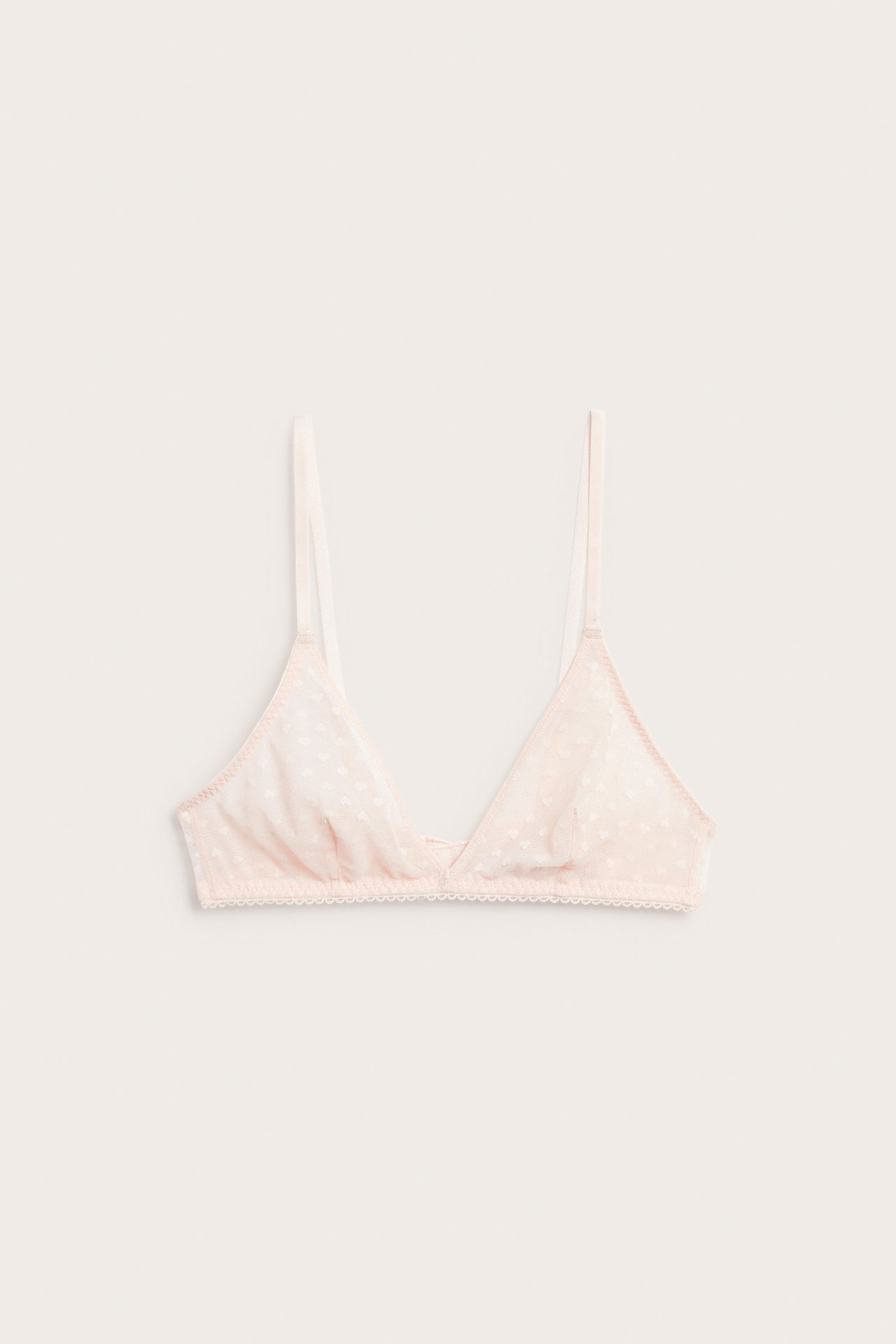 Frontbilde: Lys rosa uforet mesh-bralette med diskret hjertemønster, smale stropper og blondekant.