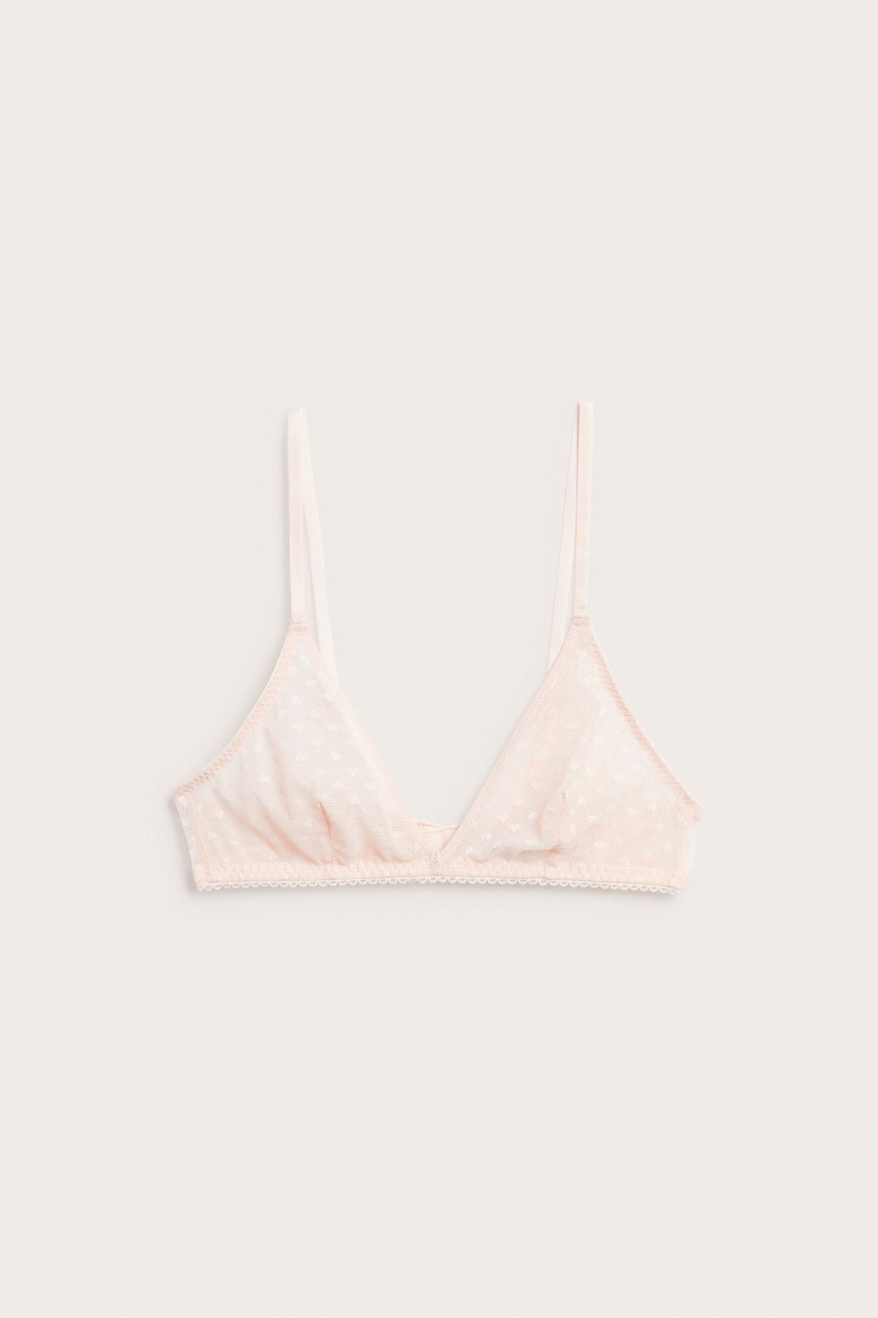 Frontbilde: Lys rosa uforet mesh-bralette med diskret hjertemønster, smale stropper og blondekant.