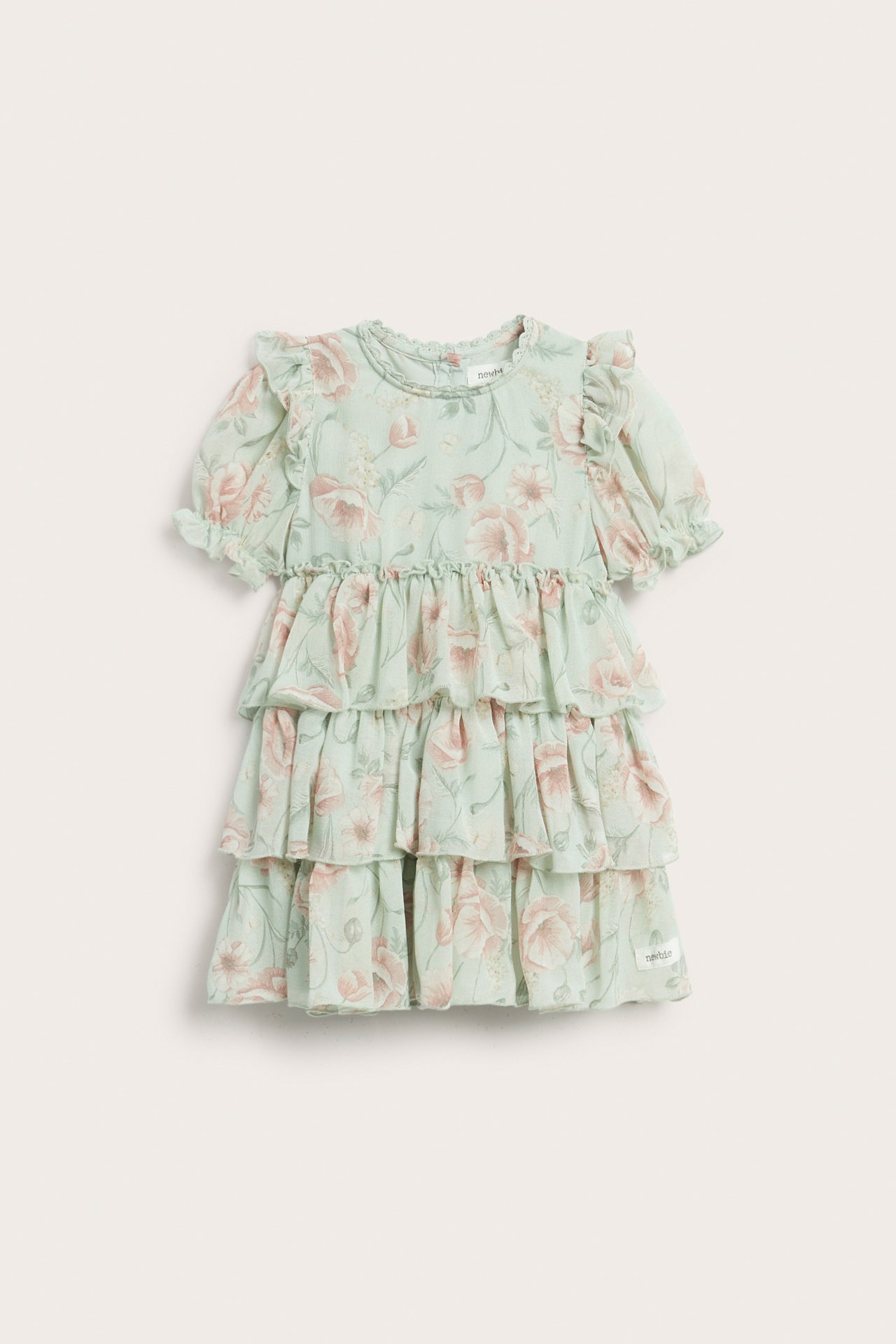 Widok z przodu: zielona szyfonowa sukienka dziecięca w kwiaty, z falbankami i bufiastymi rękawami.