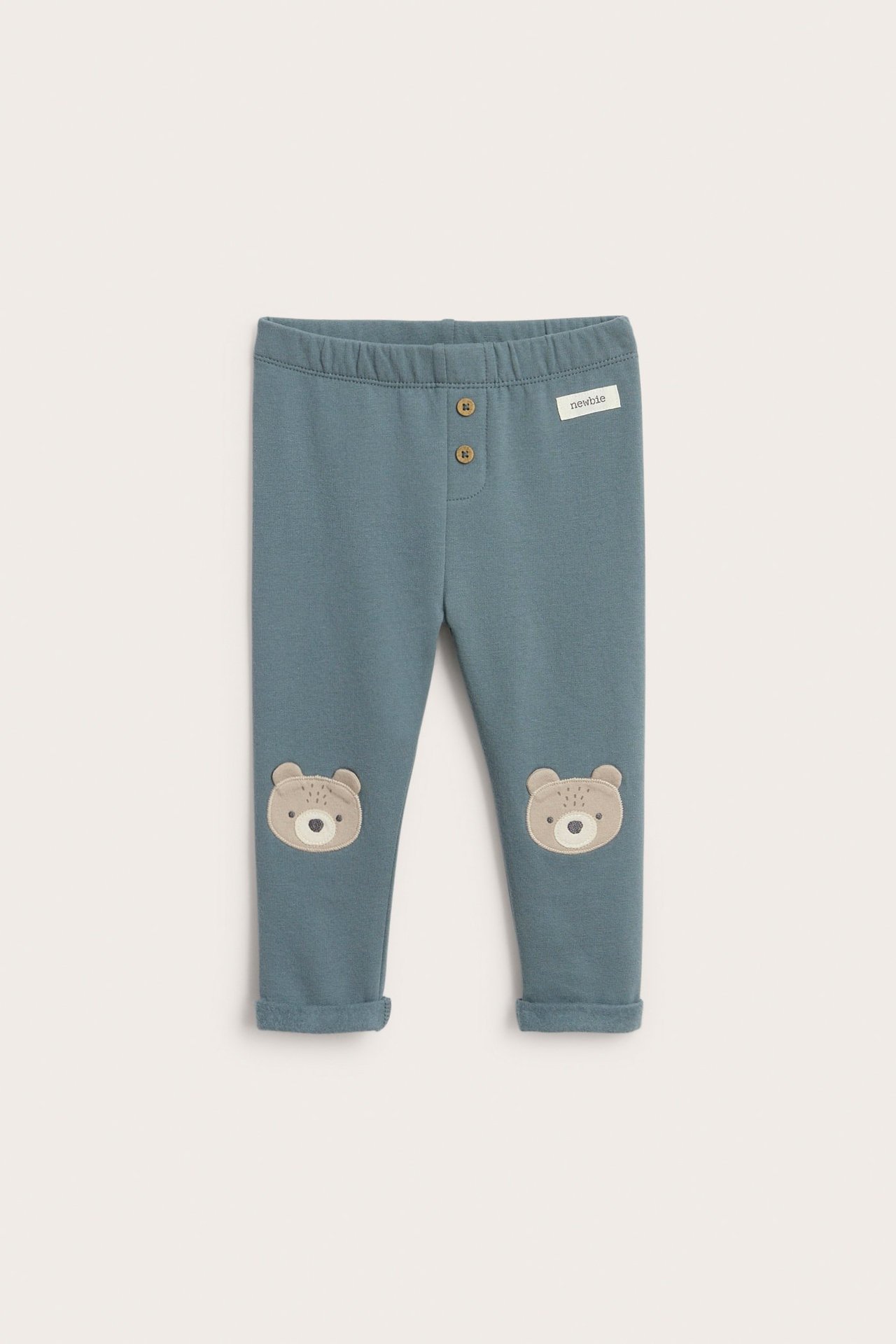 Sinisen värfliininit legginsit, polvipäällysteillä, joustava vyötärö ja kierretyt lahkeet.