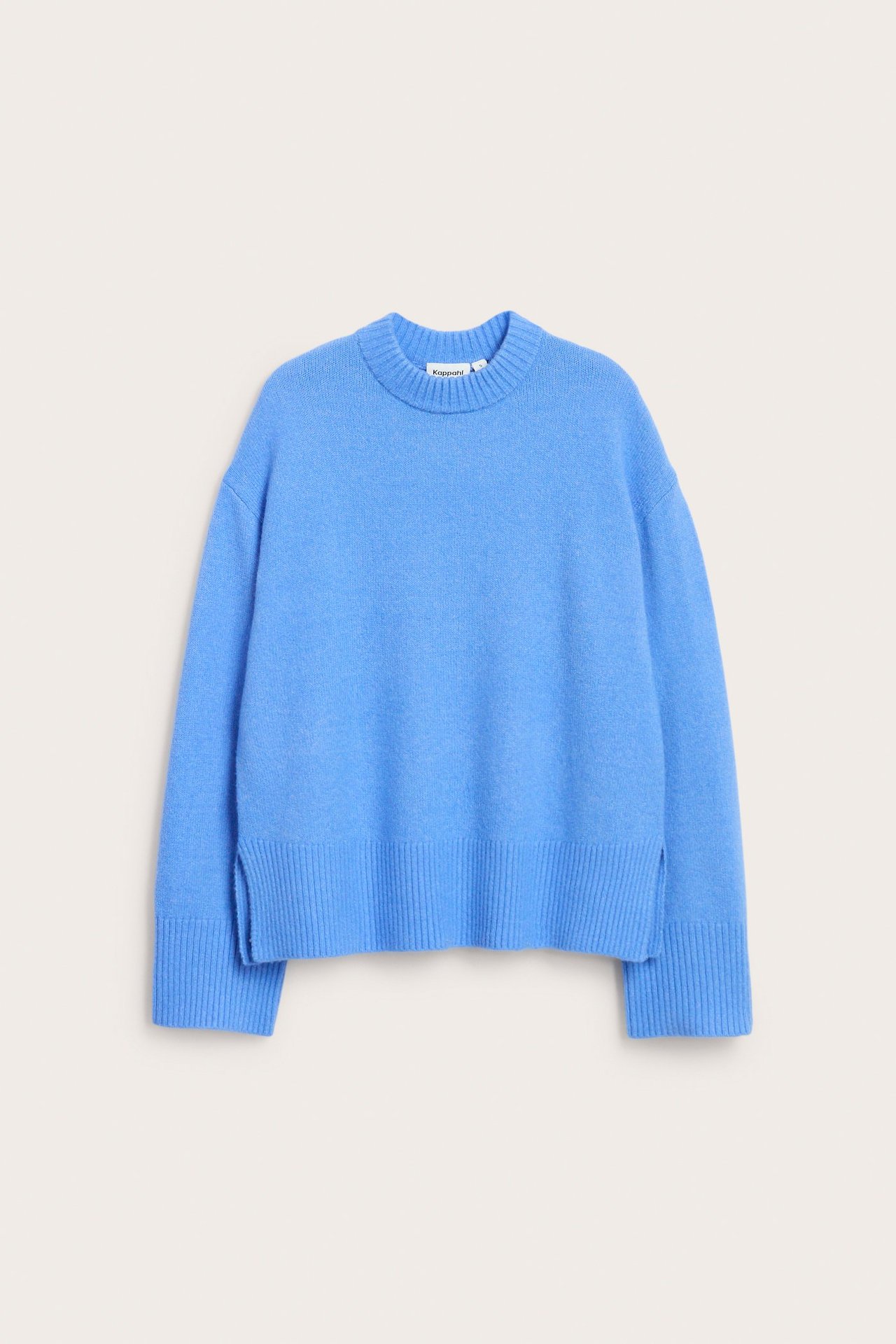 Forfra: blå strikket genser i avslappet passform med rund hals og ribbekant med sidesplitter.
