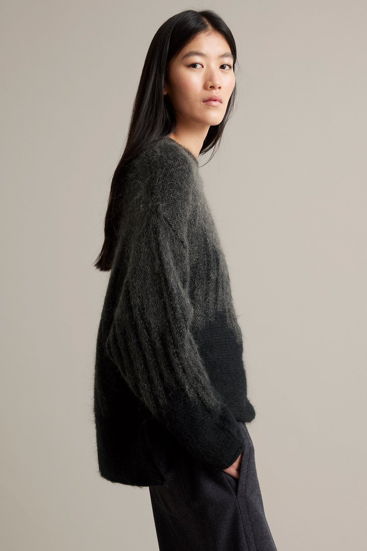 Rentoinen musta jacquard-villasekoitushuivi naismallin sivulta.