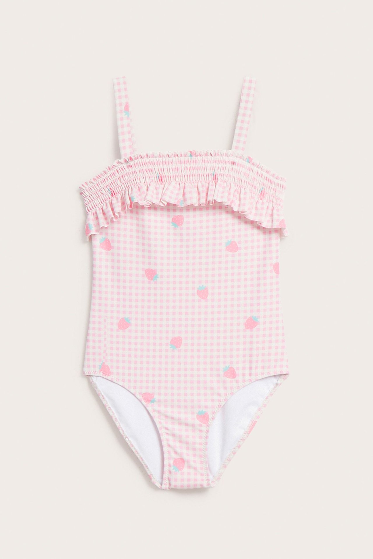 Edestä: vaaleanpunainen ruudullinen lasten uimapuku mansikkakuvioinnilla, smock- ja röyhelöyksityiskohdat.