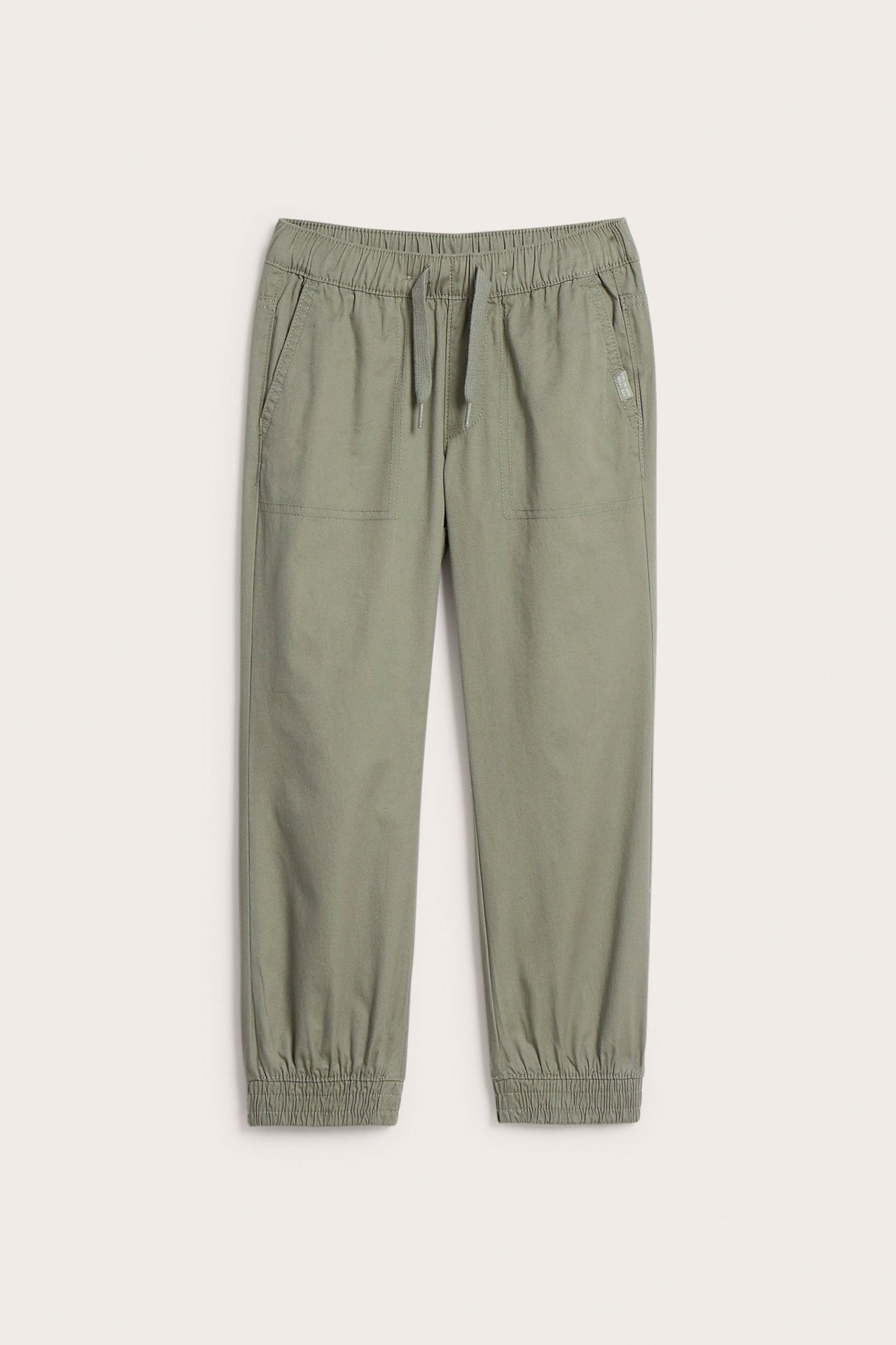 Edestä: Khakinvihreät kudotut puuvillahousut lapsille, joissa joustava vyötärö, kiristysnyöri ja joustavat lahkeensuut.