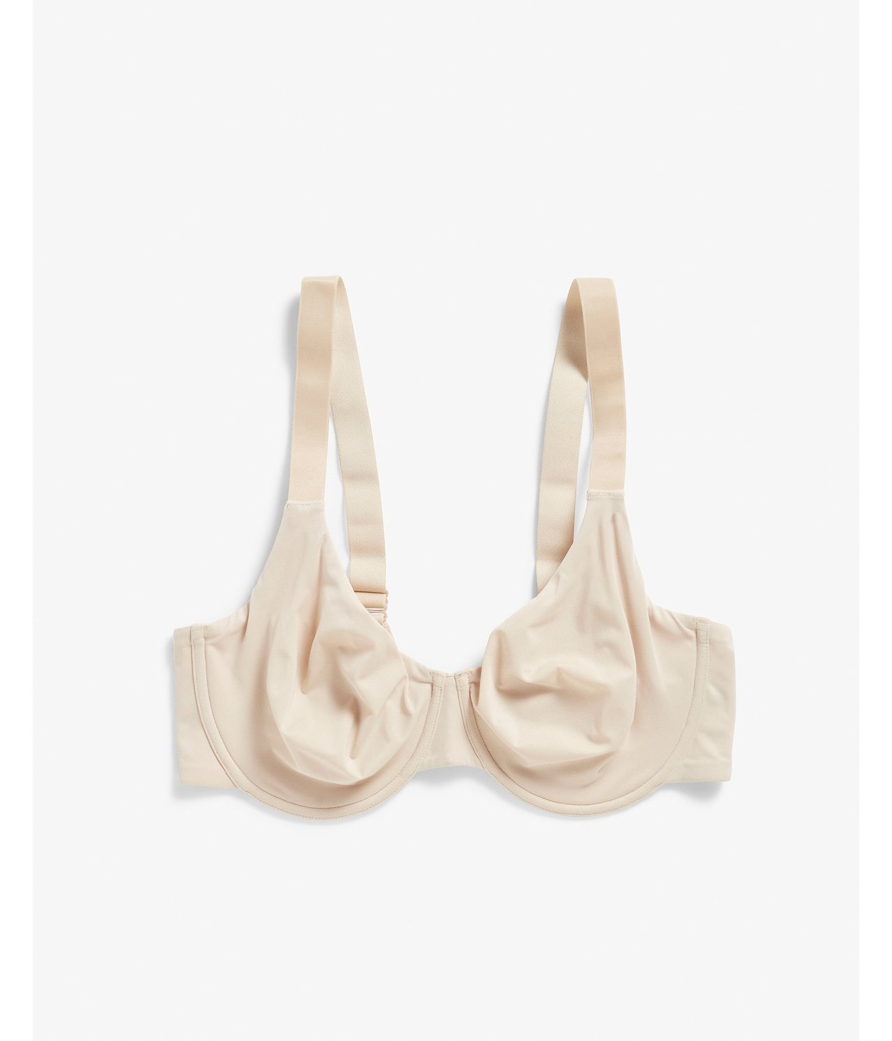 Framifrån, en ljusbeige minimizerbygel-bh med släta kupor.