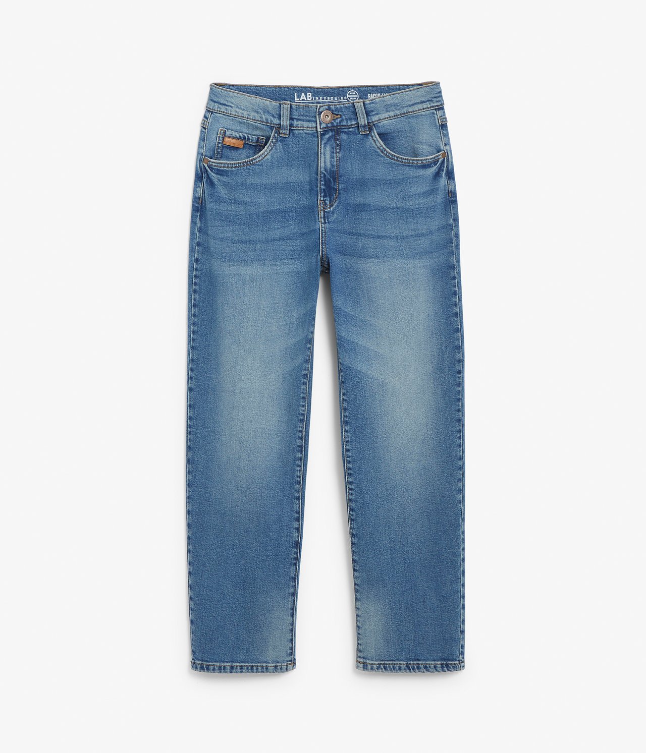 Edestä näkymä lasten sinisistä denim-baggy-löysistä farkuista vetoketjulla ja napilla.