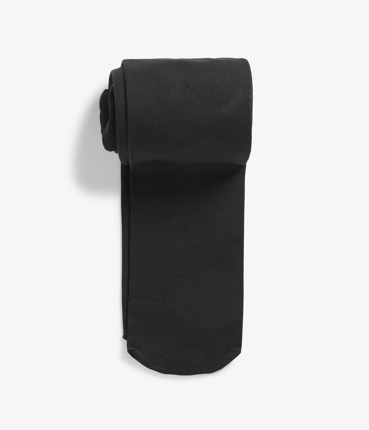 Ylhäältä näkymä taitetuista mustista 80 denierin läpinäkymättömistä sukkahousuista.