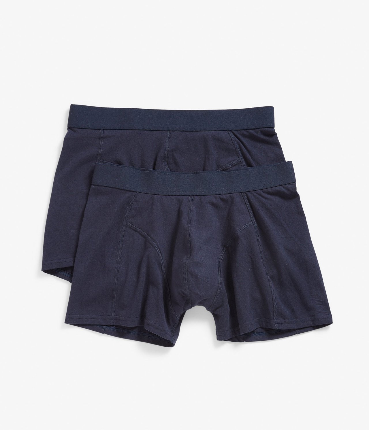 Ovenfra, to par mørkeblå ensfargede boksershorts for menn med elastisk linning.