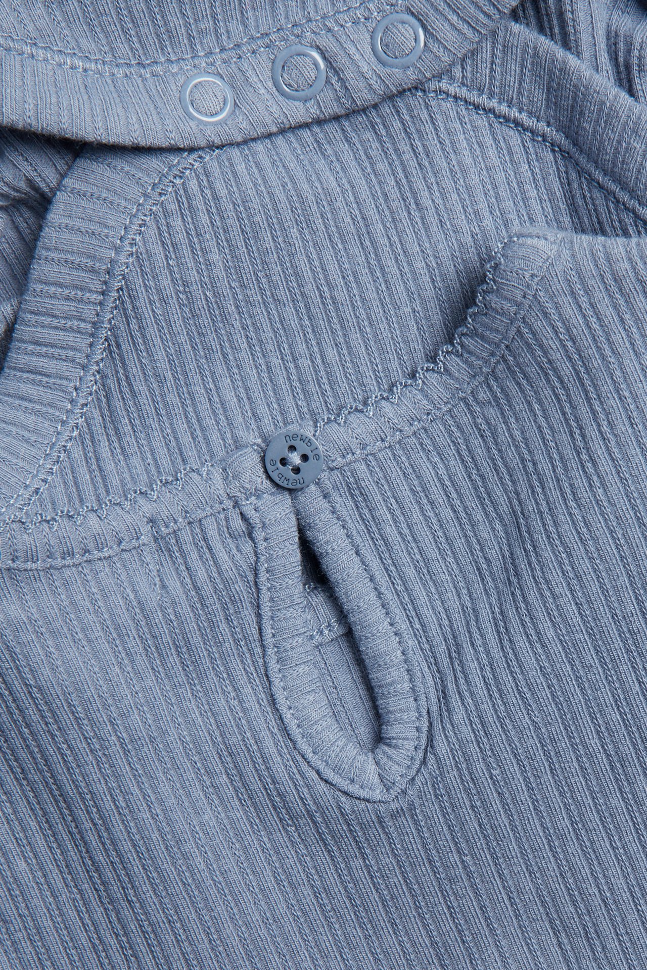 Zbliżenie niebieskiego prążkowanego body niemowlęcego z guzikiem z tyłu i napami na ramieniu.