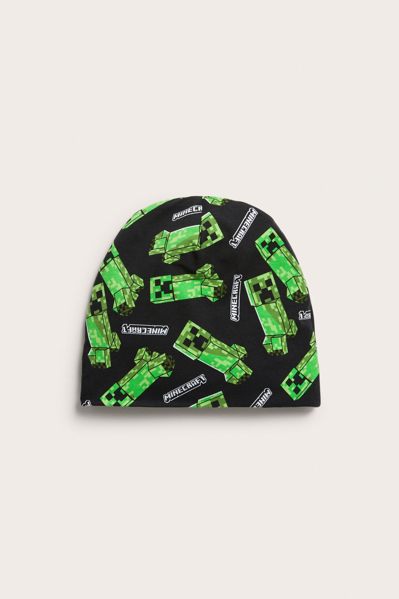 Edestä näkymä mustasta lasten jerseypiposta vihreällä Minecraft Creeper -kuviolla.