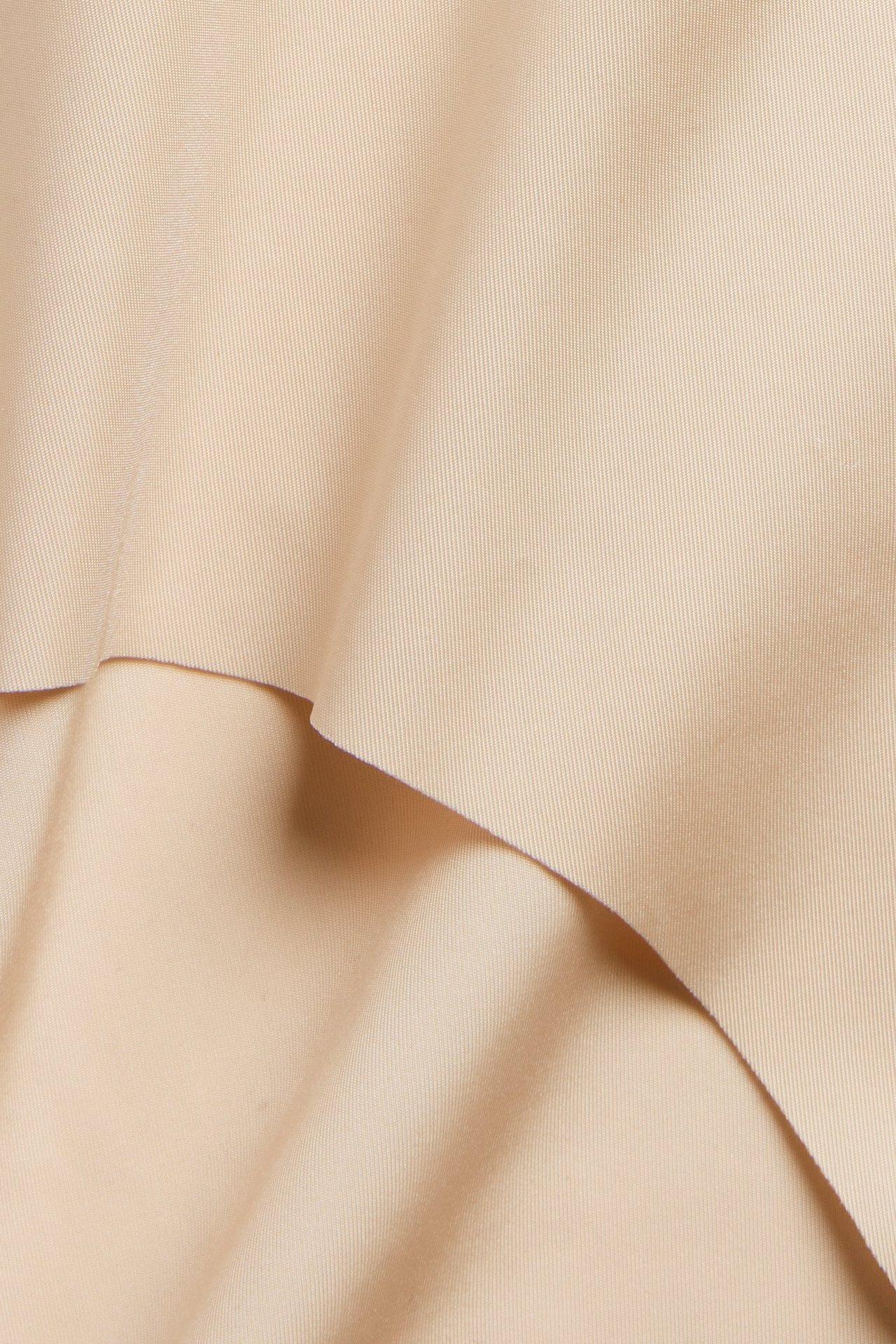 Närbild på ljusrosa, slätt microtyg, vikt, för en sömlös hipstertrosa.