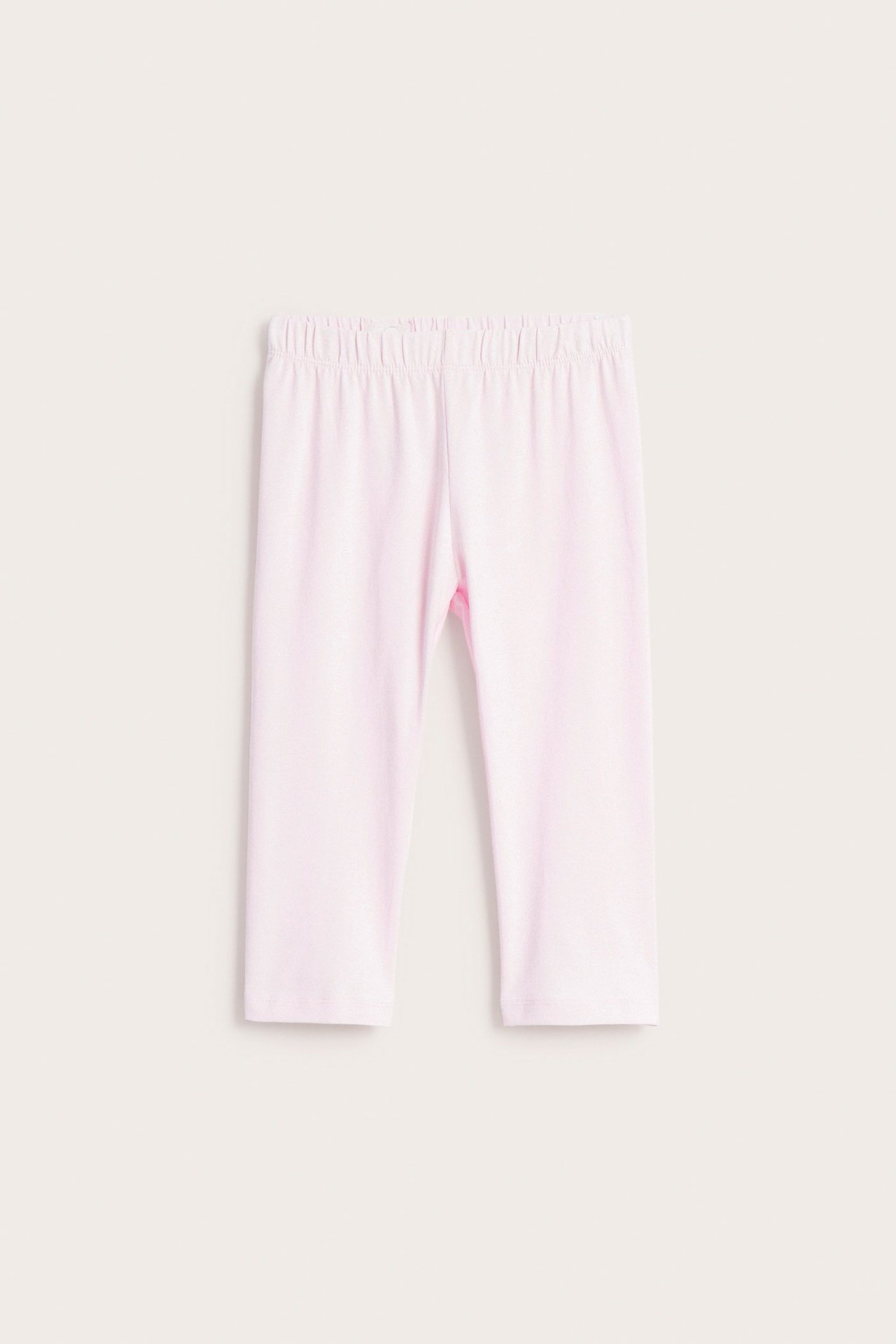Framifrån: barns enfärgade ljusrosa caprileggings med resår i midjan.