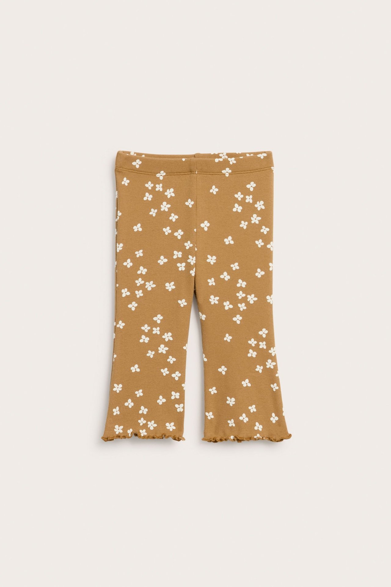 Frontvisning av brune blomstrete baby-flare-leggings med elastisk midje og volangkant.