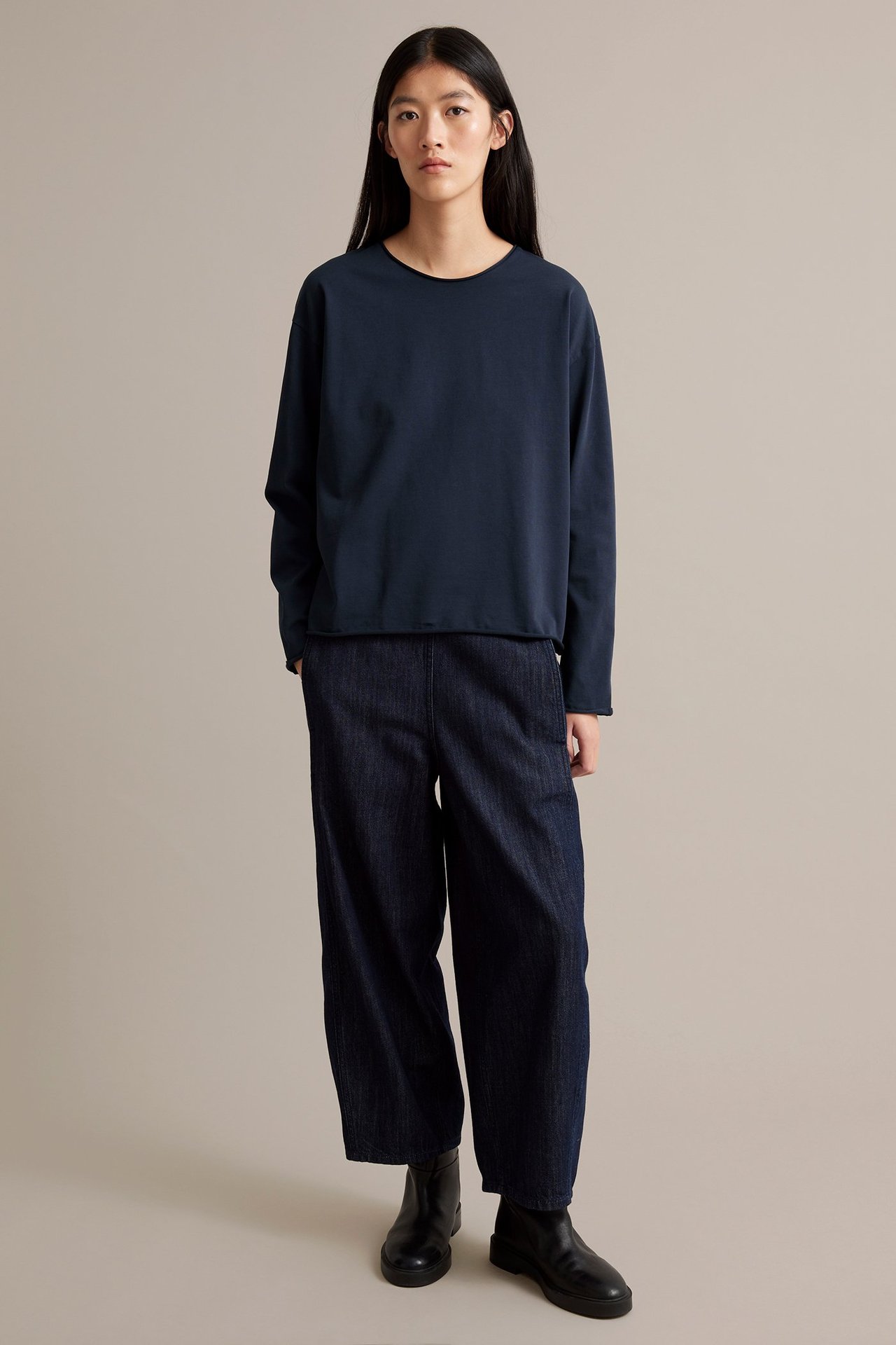 Tummansininen pitkähihainen paita paksusta trikooja, nainen päällä.