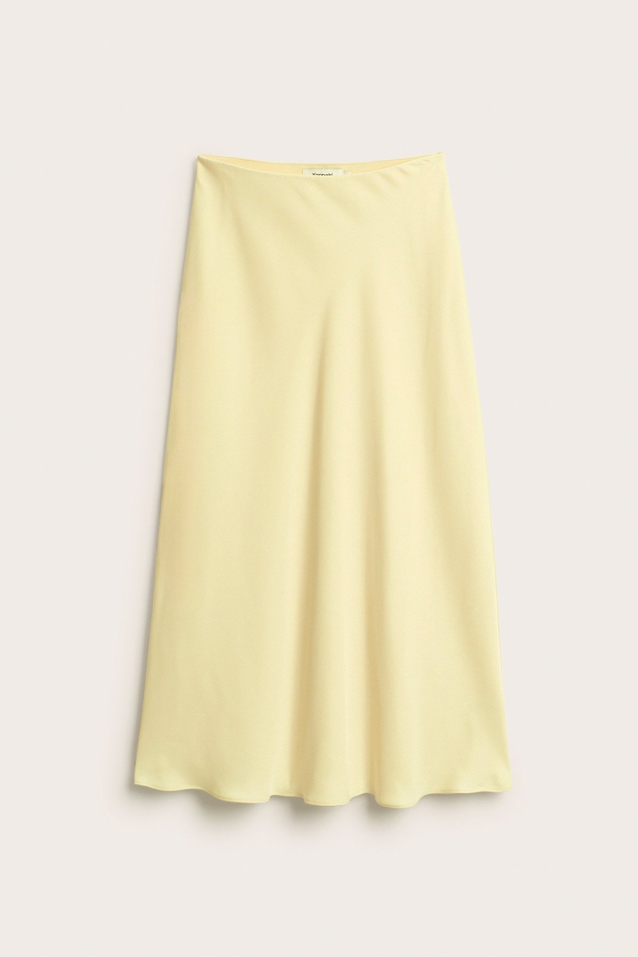 Edestä näkymä vaaleankeltaisesta, yksivärisestä, kevyesti levenevästä satiinihameesta polyesteristä.
