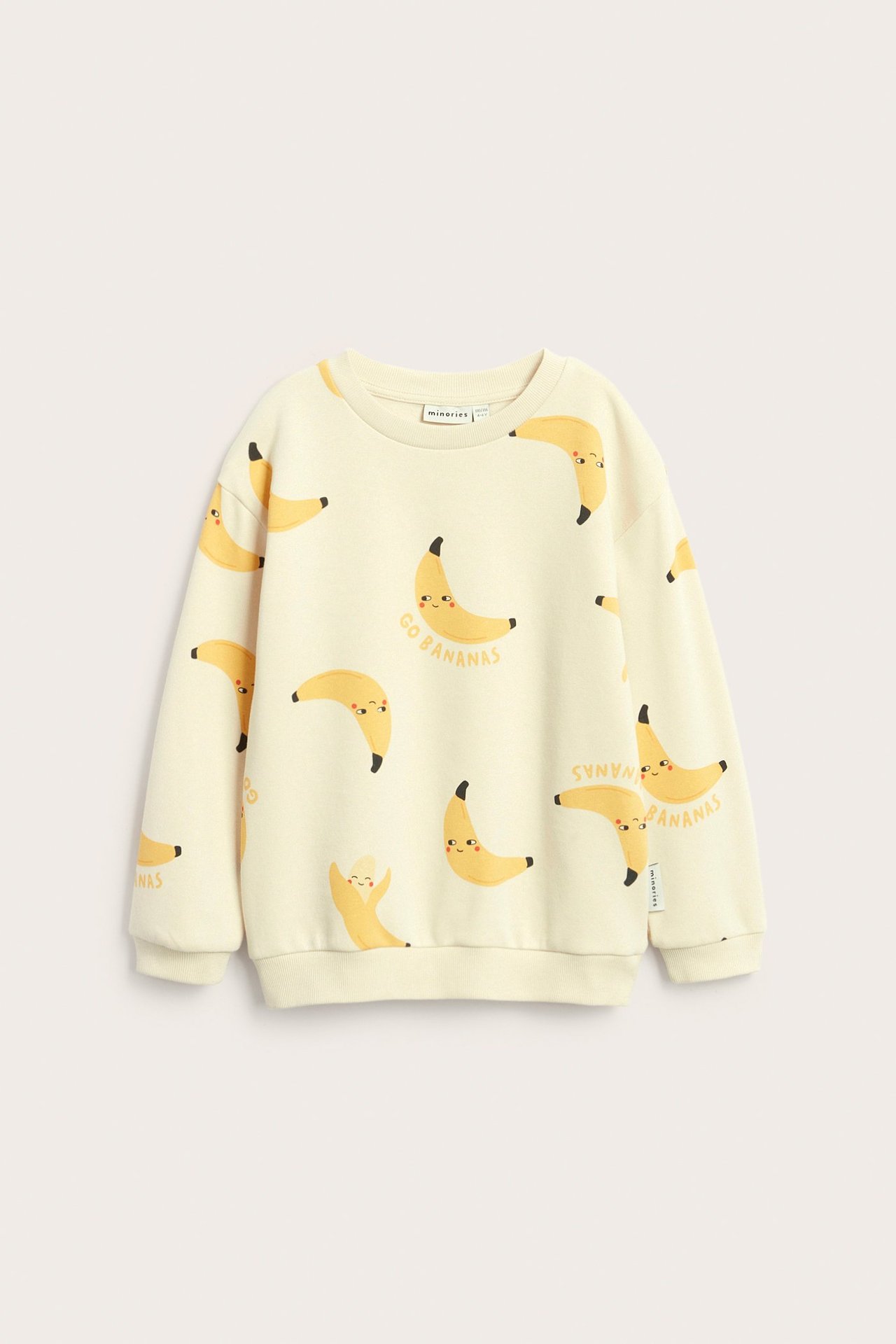 Forfra, en beige barnesweatshirt i bomullsblanding med bananmønster og teksten 'Go Bananas'.