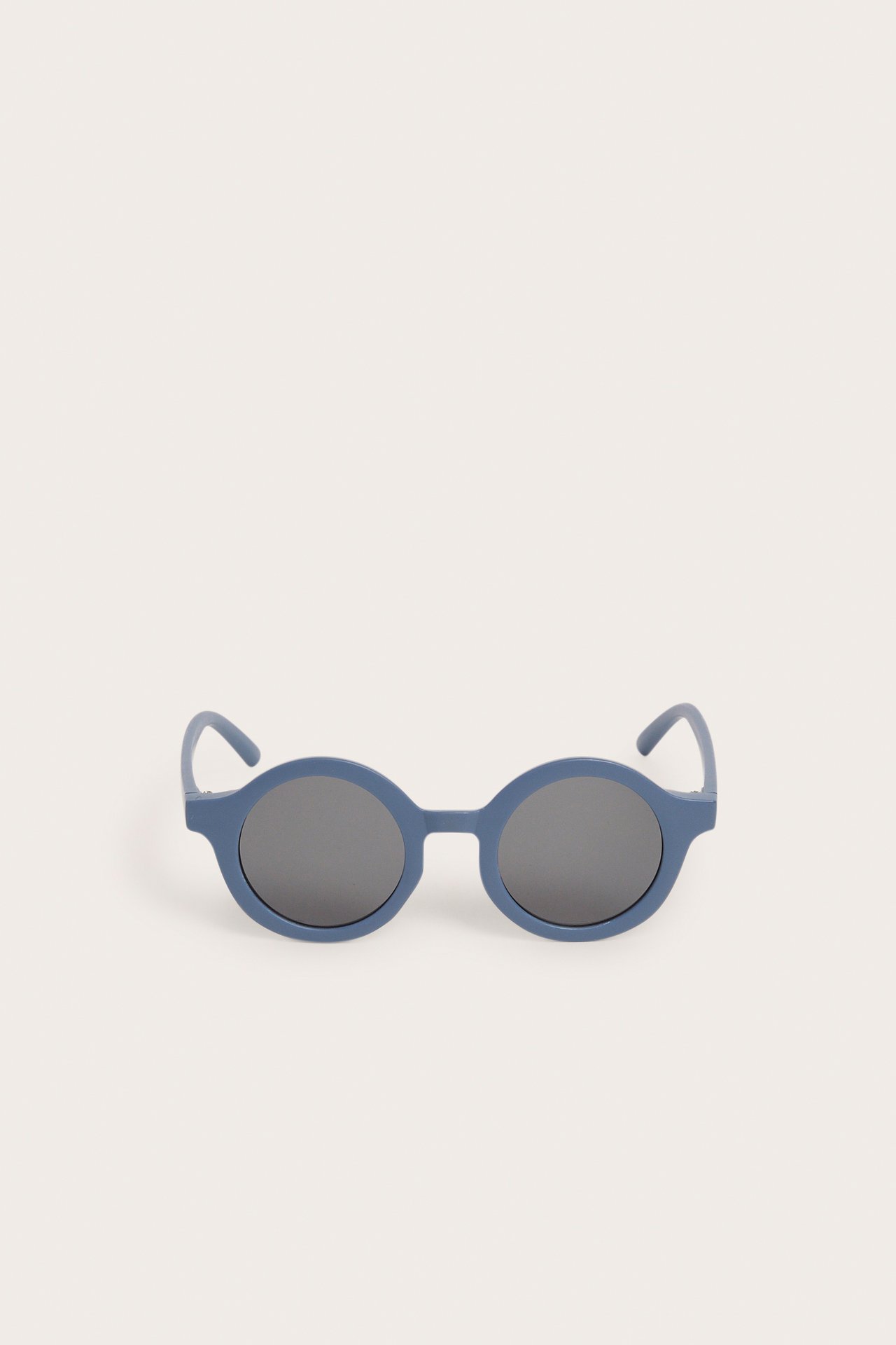 Widok z przodu niebieskich, okrągłych okularów przeciwsłonecznych z ciemnymi soczewkami.