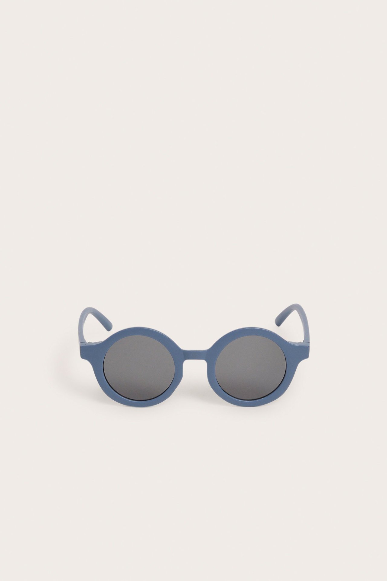 Widok z przodu niebieskich, okrągłych okularów przeciwsłonecznych z ciemnymi soczewkami.