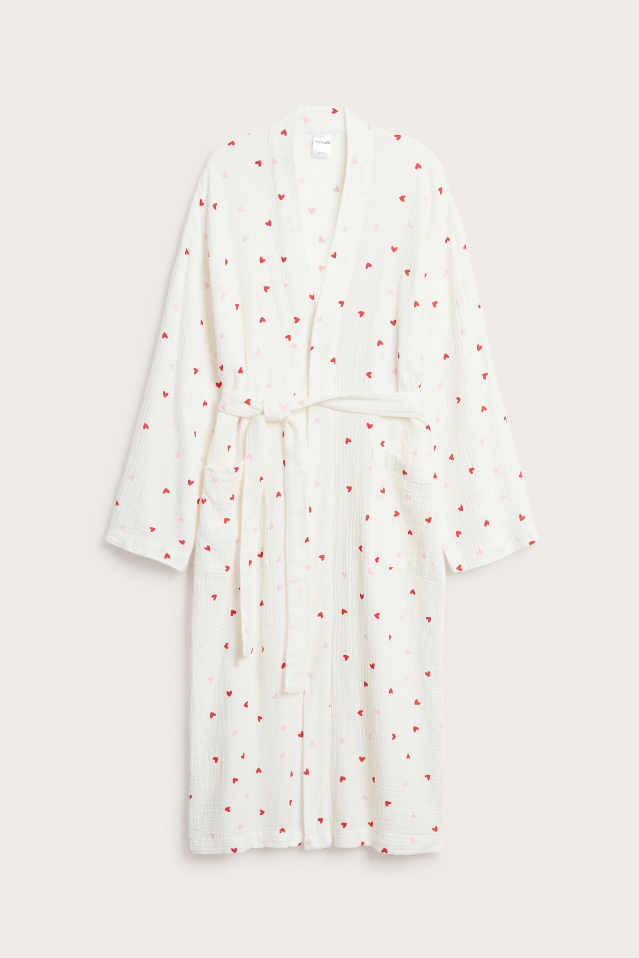 Widok z przodu: Ecru bawełniany szlafrok z czerwonymi sercami, wiązanym paskiem i kieszeniami.