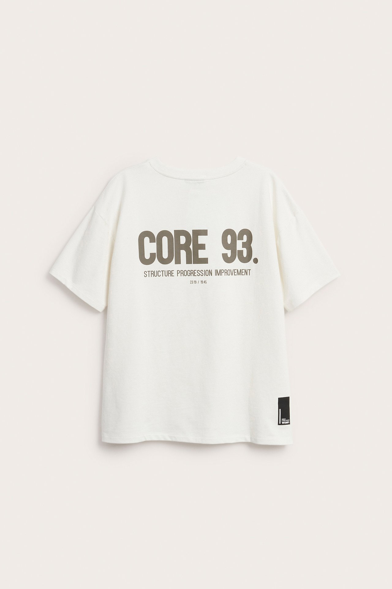 Lasten valkoinen oversize-puuvillapaita, takaa nähtynä, isolla harmaalla 'CORE 93.' -painatuksella.
