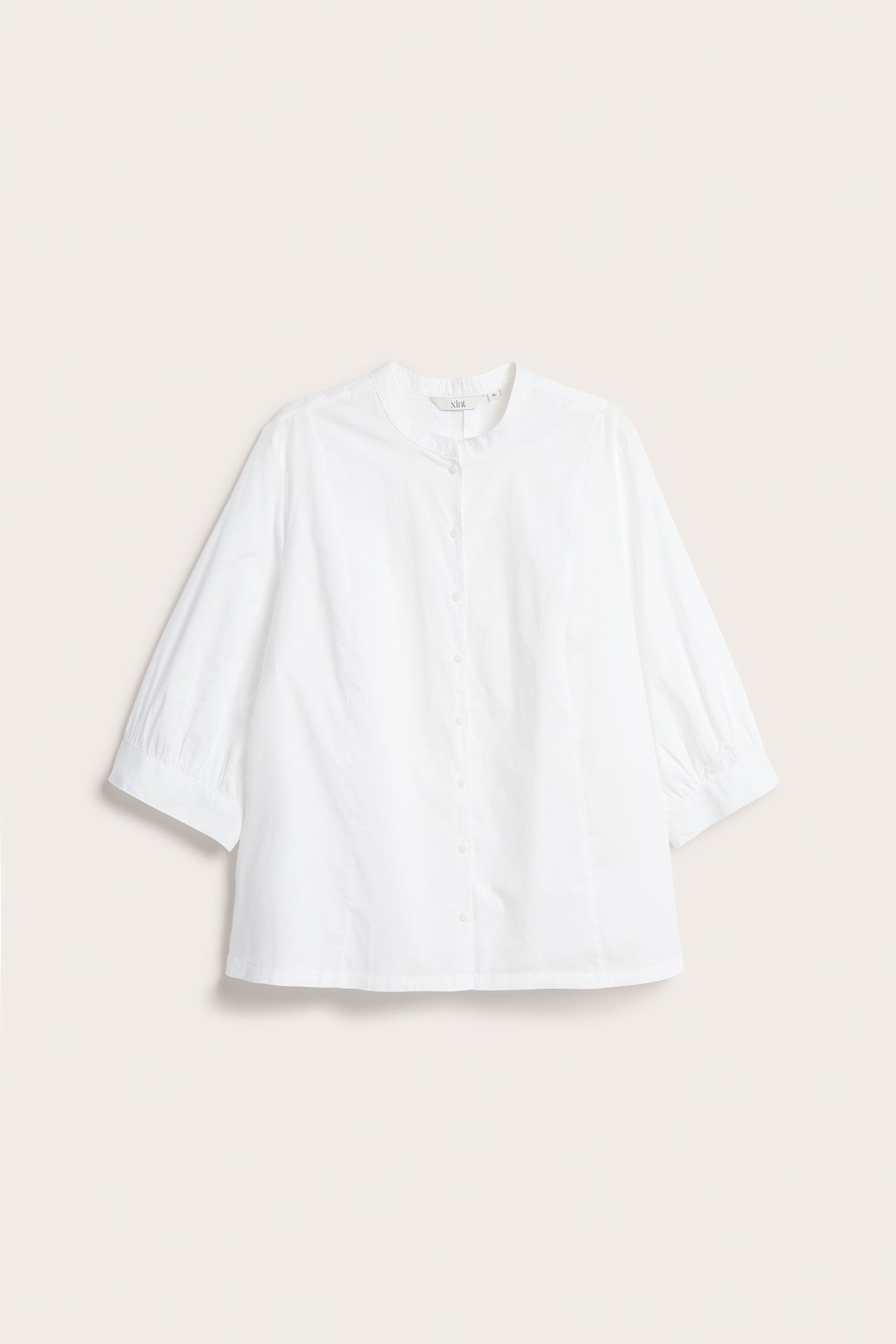 Biała, bezkołnierzowa bluzka bawełniana z rękawami 3/4 typu bufka i guzikami, widok z przodu.