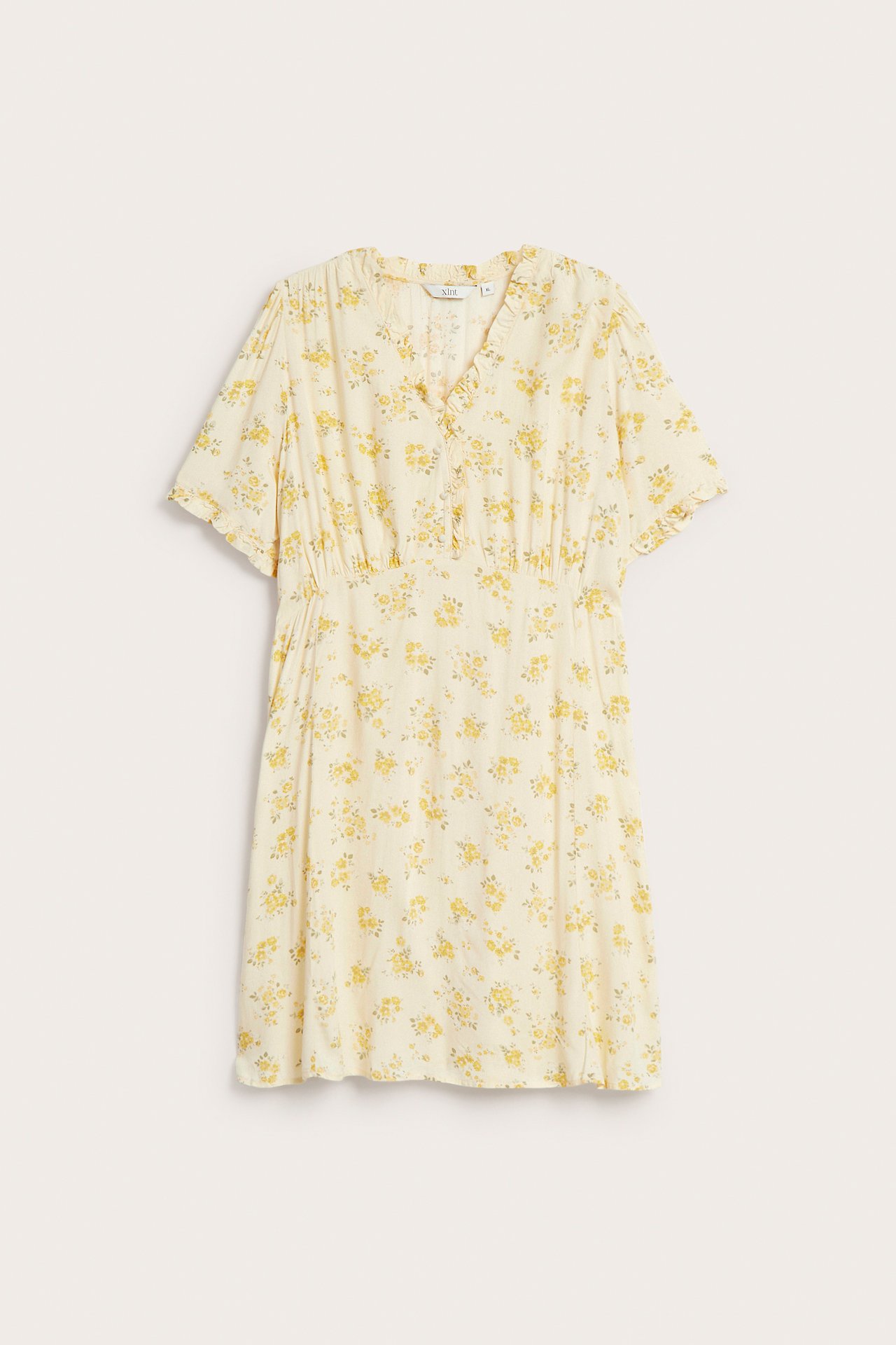 Edestä: Vaaleankeltainen kukkakuvioinen viskoosimekko, V-pääntie, päällystetyt napit, joustovyötärö.