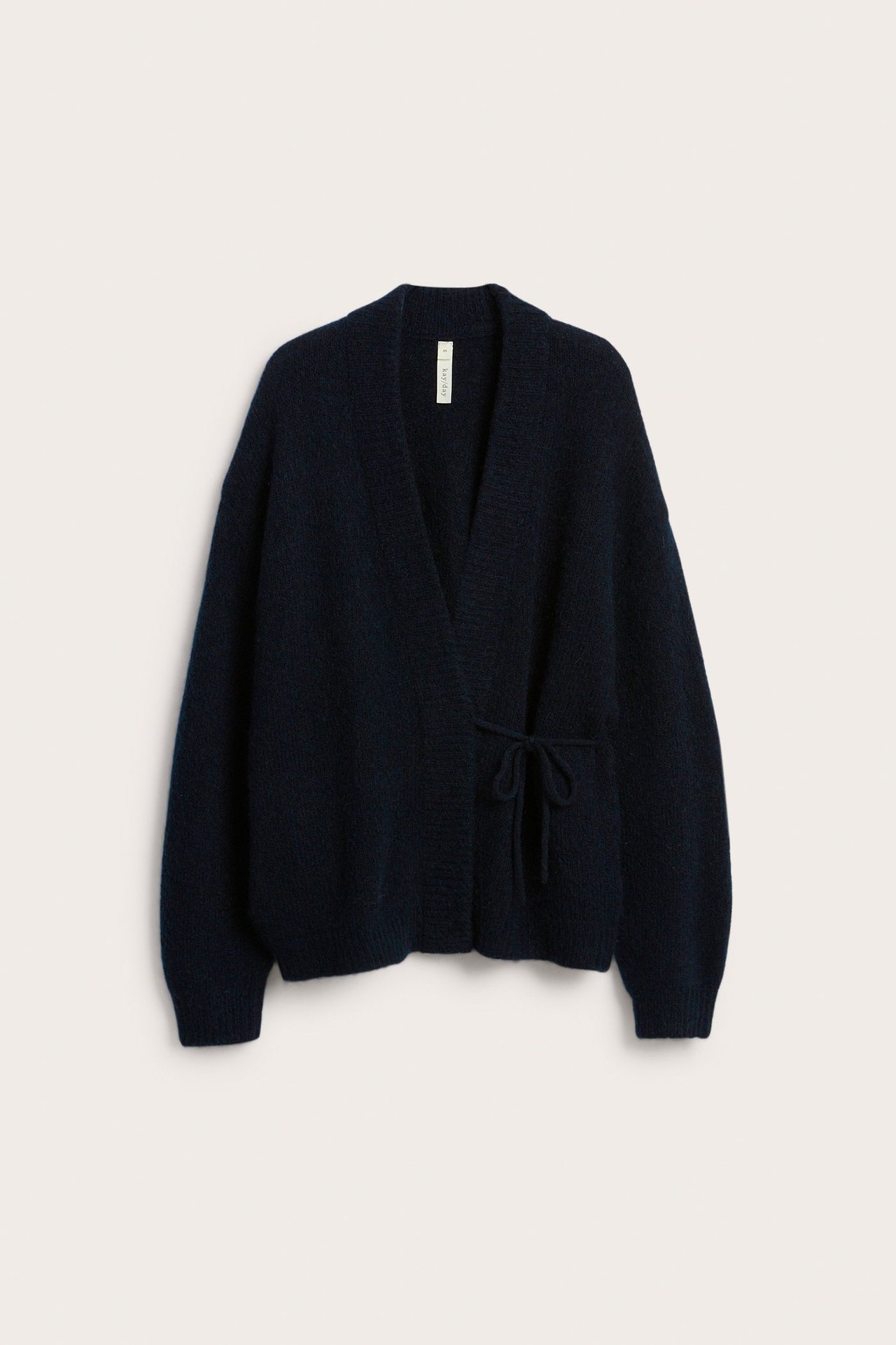 Edestäpäin kuvattu tummansininen villasekoitejakku, jossa on kietaisumalli ja solmittava nauhakiinnitys.