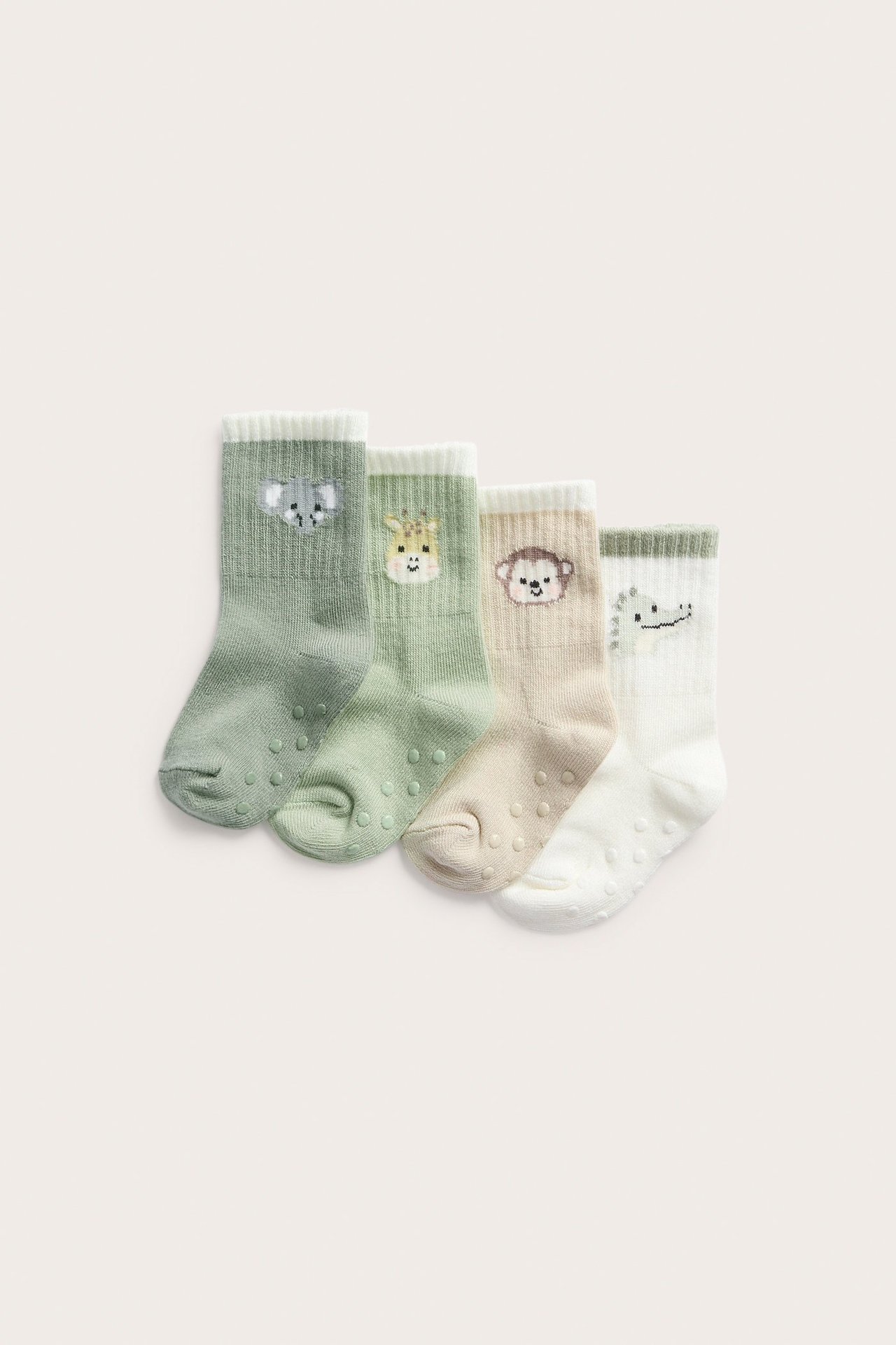 Ylhäältä: Neljä moniväristä vauvan puuvillasukkaa, eläinkuvioin ja liukuestepohjin.