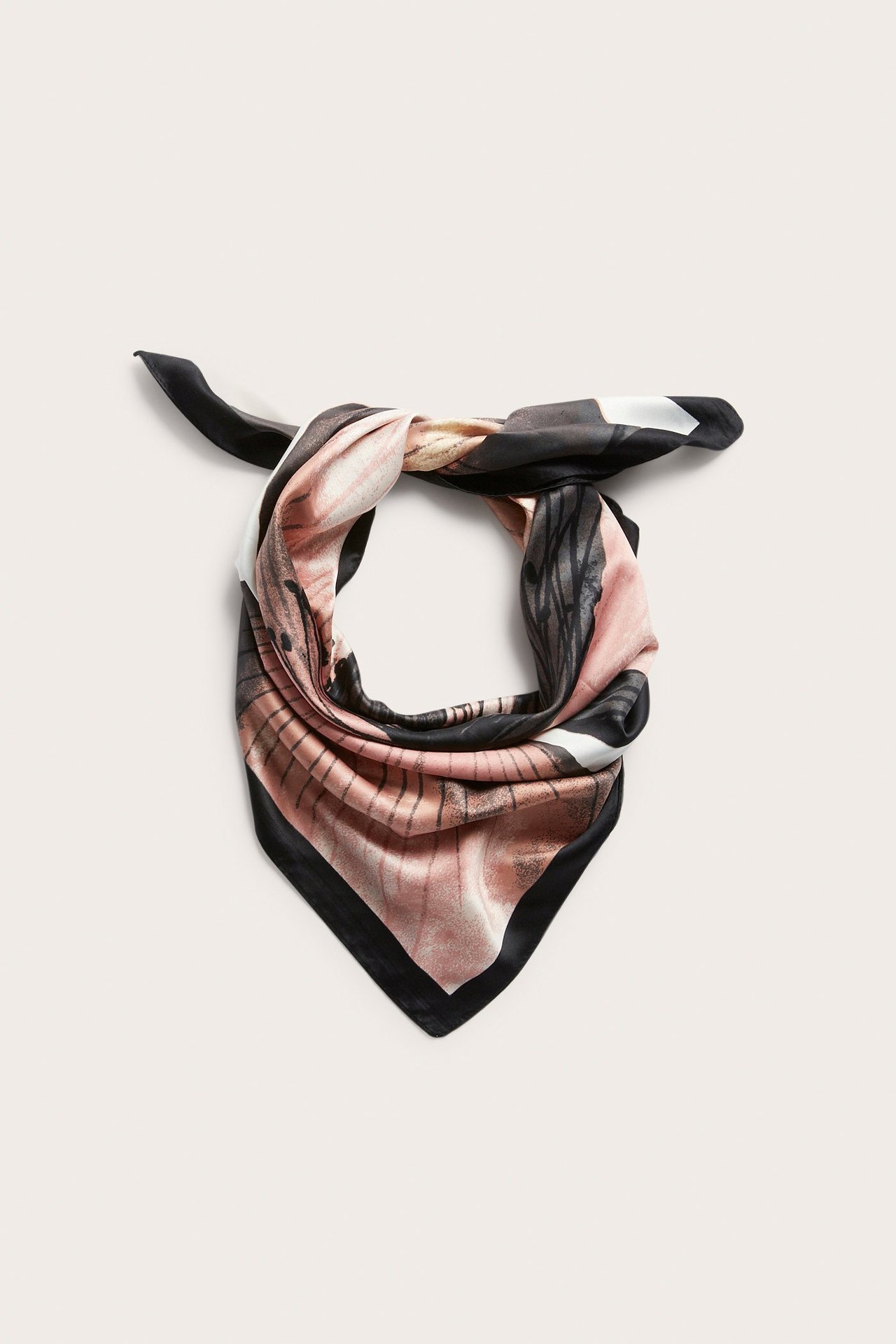 Frontbilde av et knyttet kvadratisk skjerf i lys rosa, svart og hvit polyester med blomstermønster.