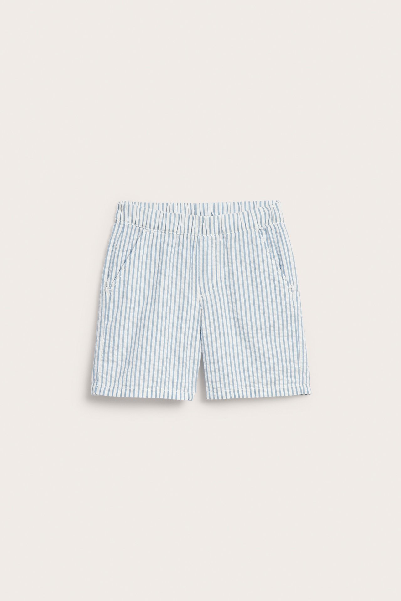 Edestä: Lasten vaaleansiniset ja valkoiset raidalliset seersucker-puuvillashortsit joustavalla vyötäröllä, taskut.