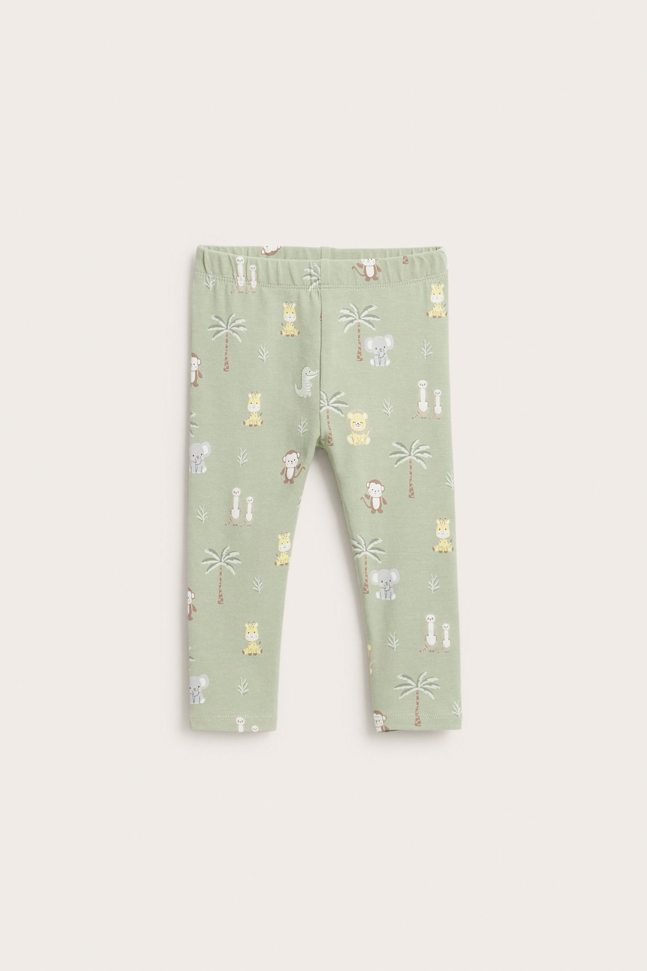 Edestäpäin, vihreät vauvan leggingsit leikkisällä eläin- ja palmukuviolla sekä joustavalla vyötäröllä.
