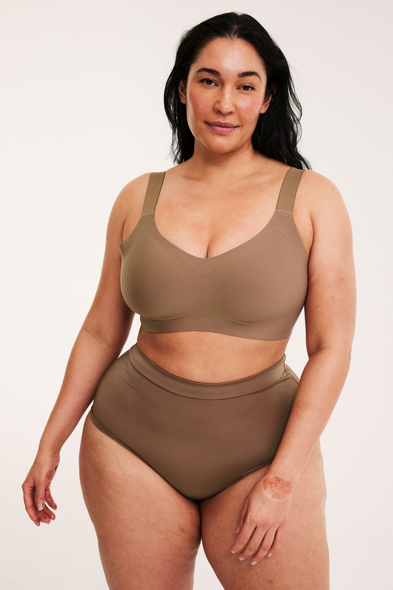 Framifrån: kvinna i sömlös brun "micro" högmidjad trosa och matchande behå.