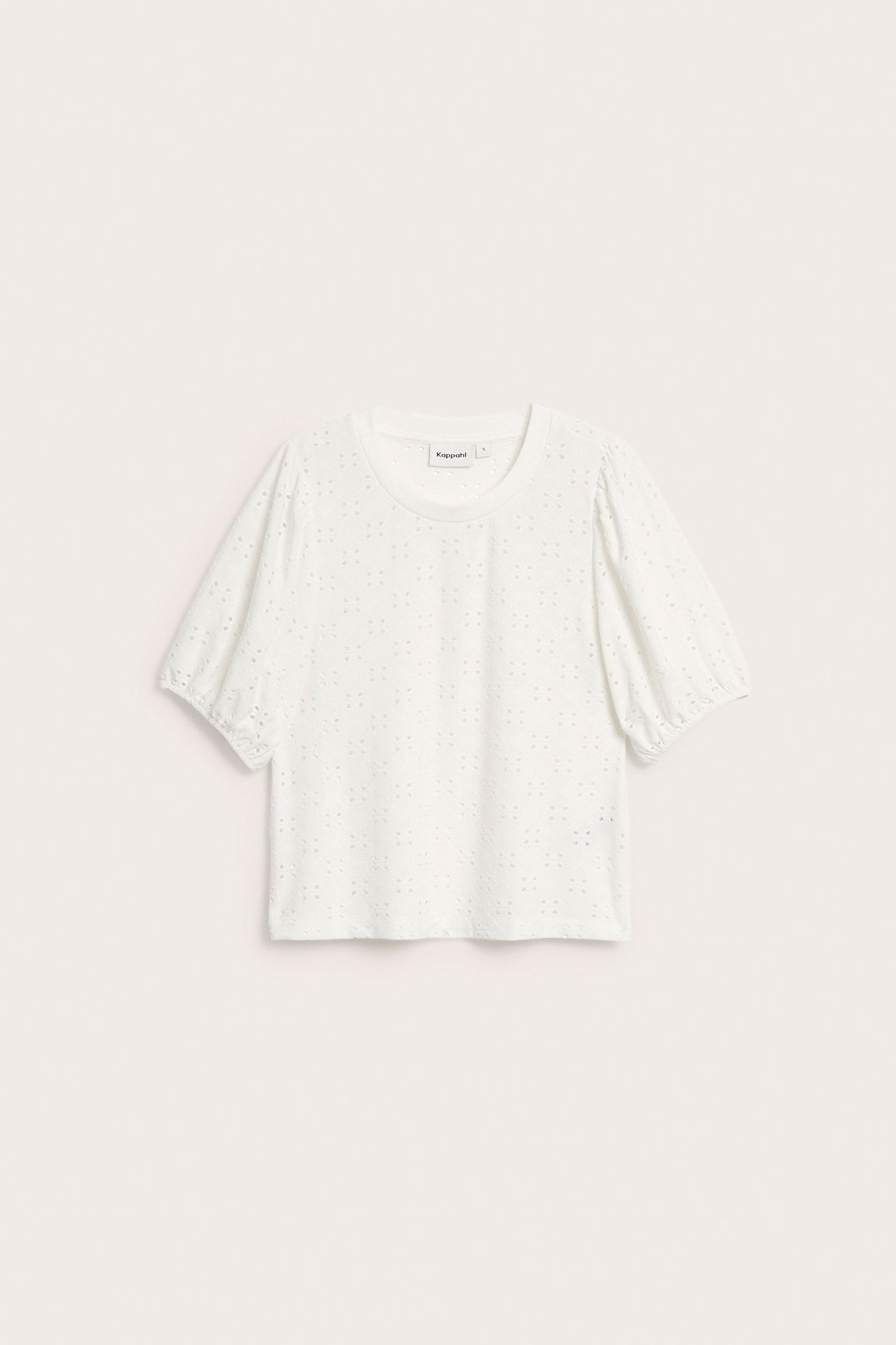 Edestäpäin nähty luonnonvalkoinen broderie anglaise -toppi pöyhkeähihoilla ja pyöreällä kaula-aukolla.