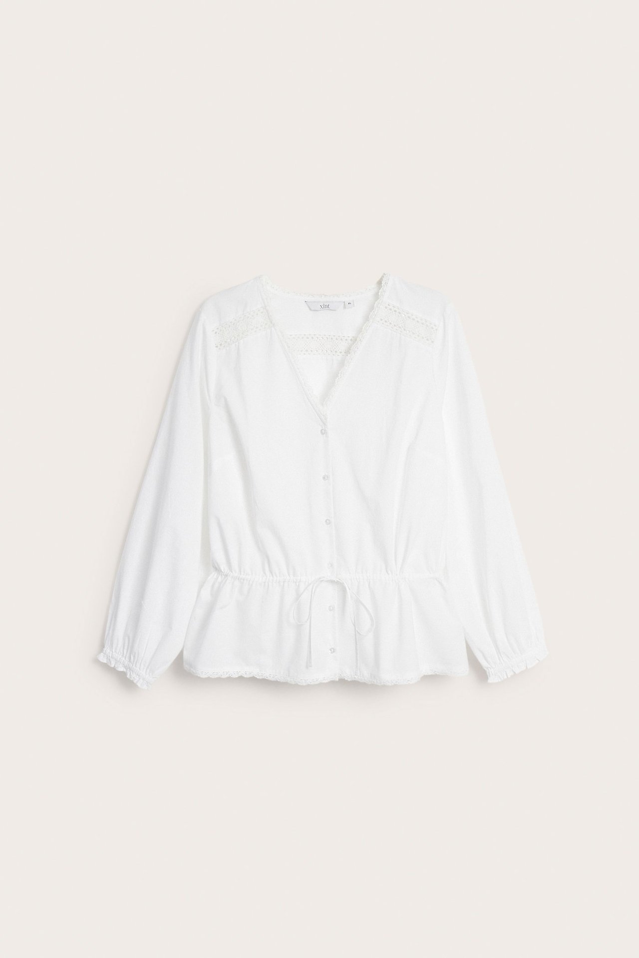 Widok z przodu: biała bawełniana bluzka z koronką, ściągaczem w talii i elastycznymi mankietami.