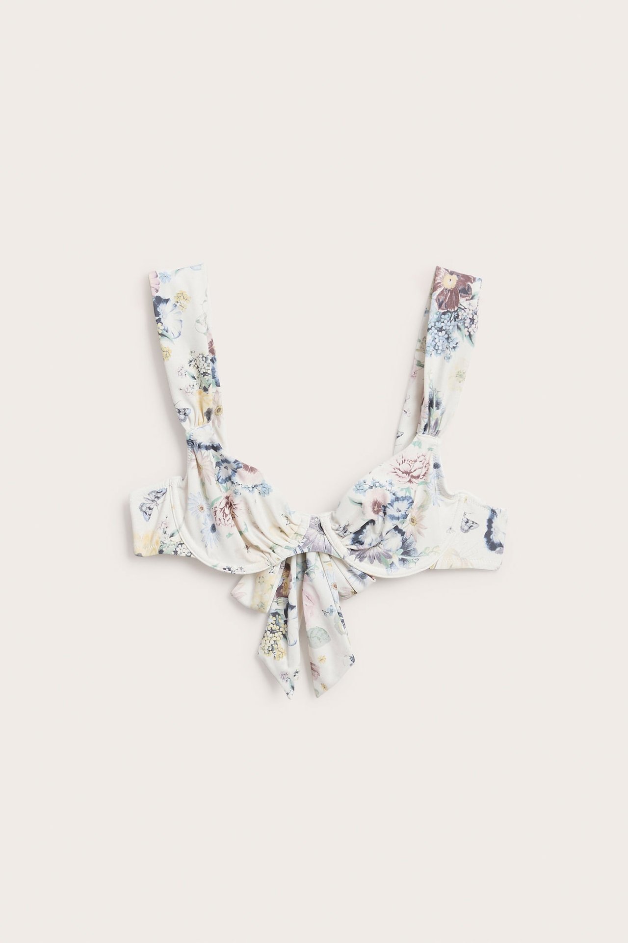 Frontvisning av en offwhite blomstret bikinitopp med bøyler, brede stropper og knyting foran.