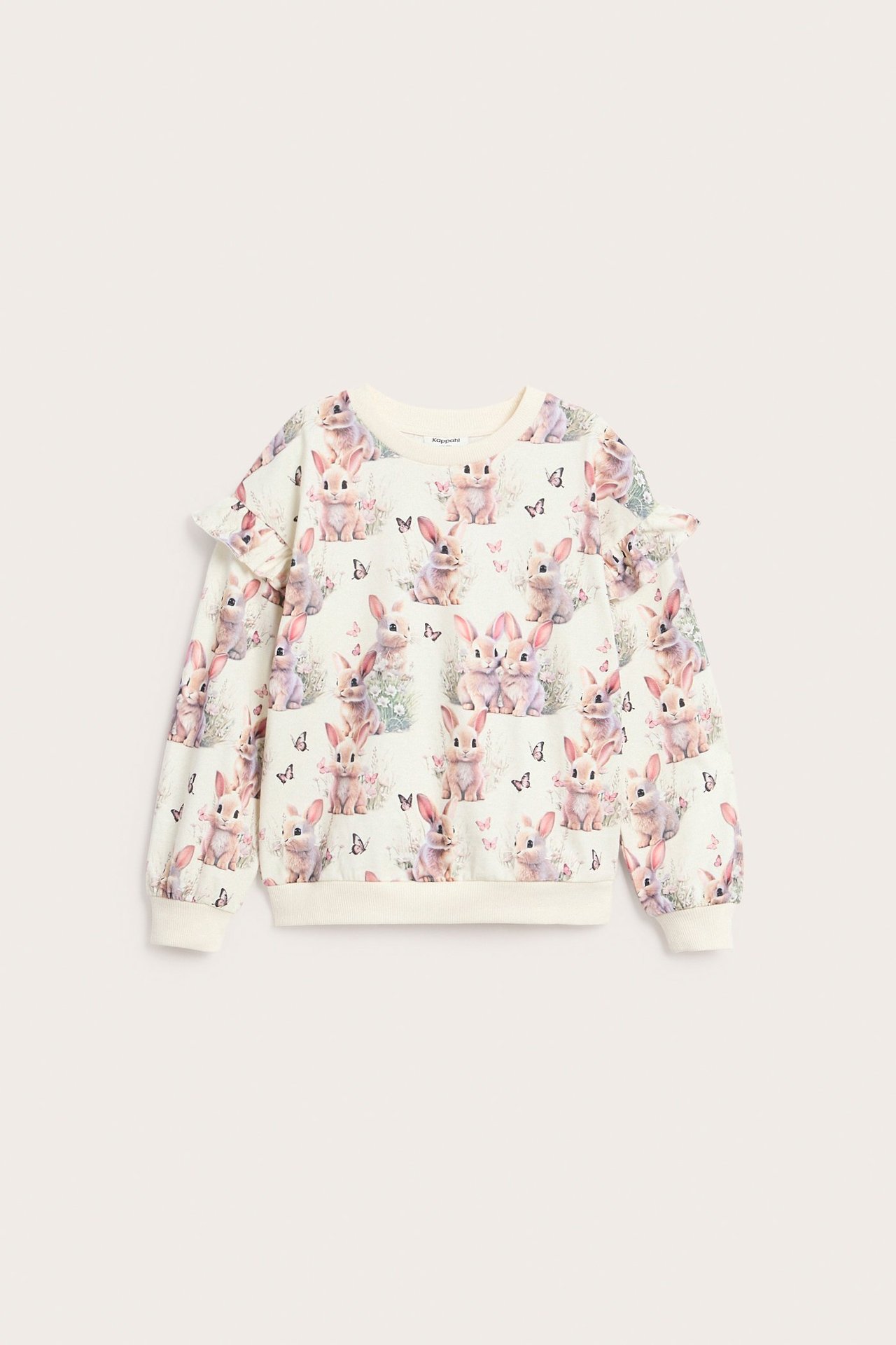 Edestäpäin: lasten luonnonvalkoinen puuvillaneulepaita kauttaaltaan kanikuvioitu, röyhelöhihoilla.