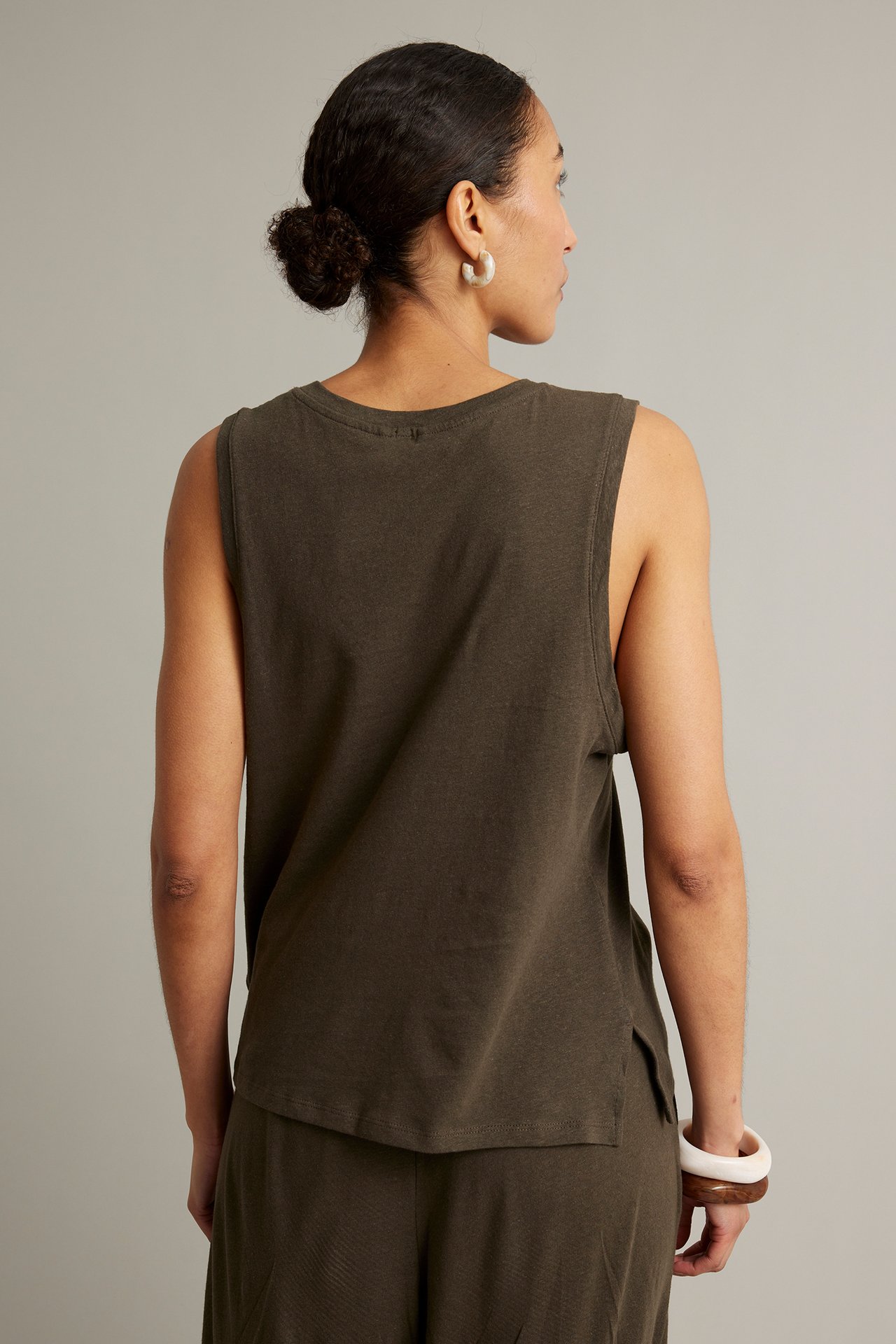 Bakifrån, kvinna i brun tanktopp i linne- och bomullsblandning, matchande culottebyxor, vita örhängen, armband.