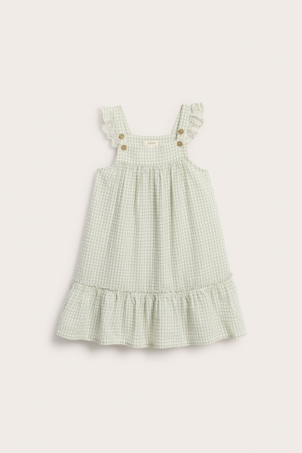 Edestä: Lasten vaaleanvihreä ruudullinen mekko, jossa kirjailtuja olkarypytyksiä ja rypytetty helma.
