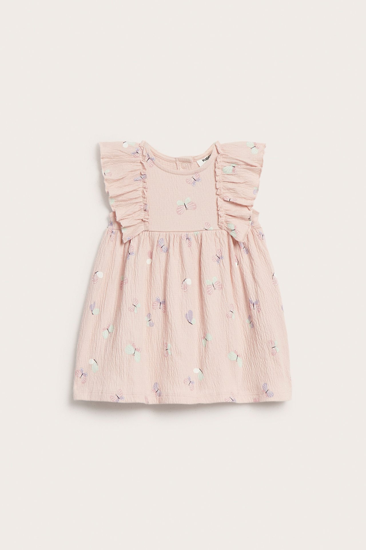 Edestä, vaaleanpunainen kreppi-trikoinen vauvanmekko, jossa röyhelöhihat, värikäs perhoskuvio ja nepparit takana.