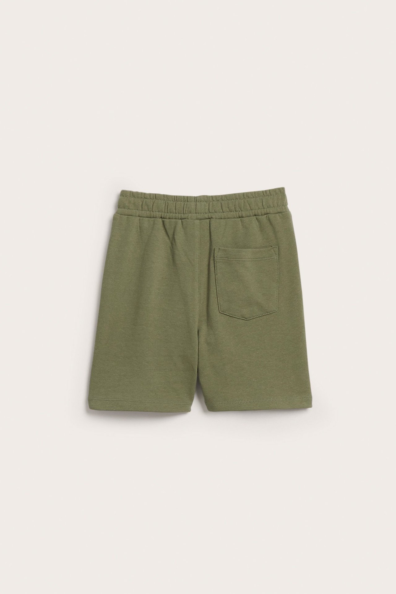 Takaapäin, yksiväriset tummanvihreät lasten collegepöksyt, joissa joustava vyötärö ja yksi takatasku.