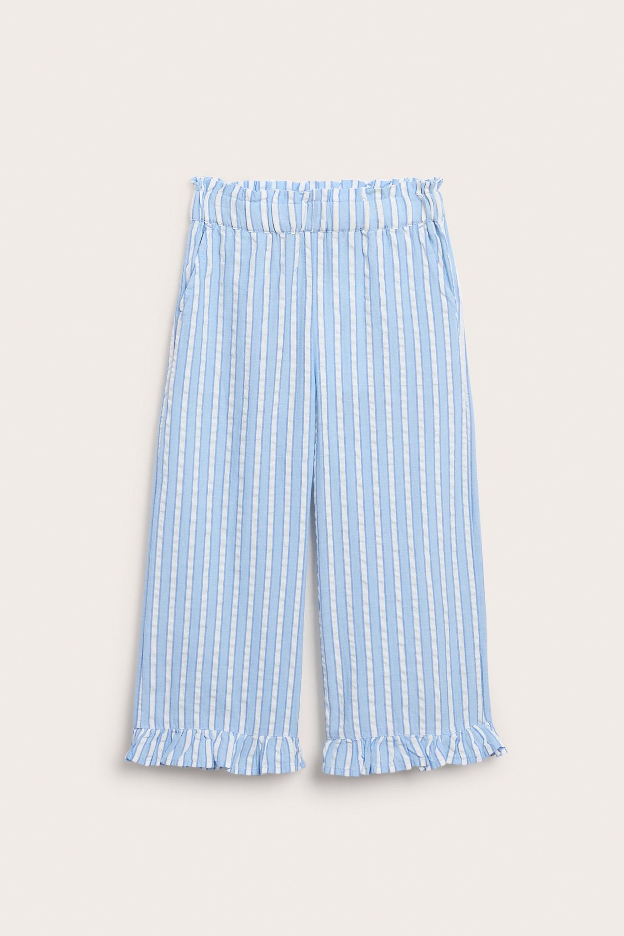 Edestäpäin: Raidalliset sinivalkoiset leveälahkeiset puuvillahousut rypytetyllä joustovyötäröllä ja volangilahkeilla.