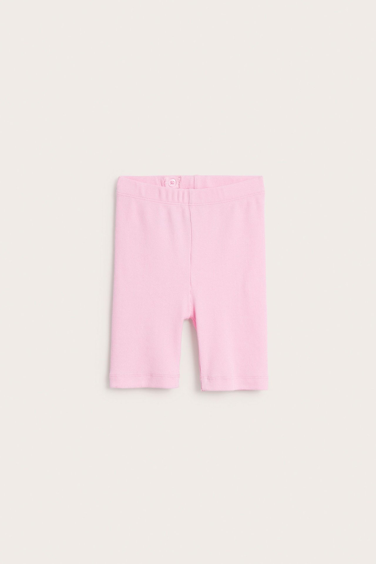 Widok z przodu różowych prążkowanych legginsów rowerowych z regulowaną talią i gumką.